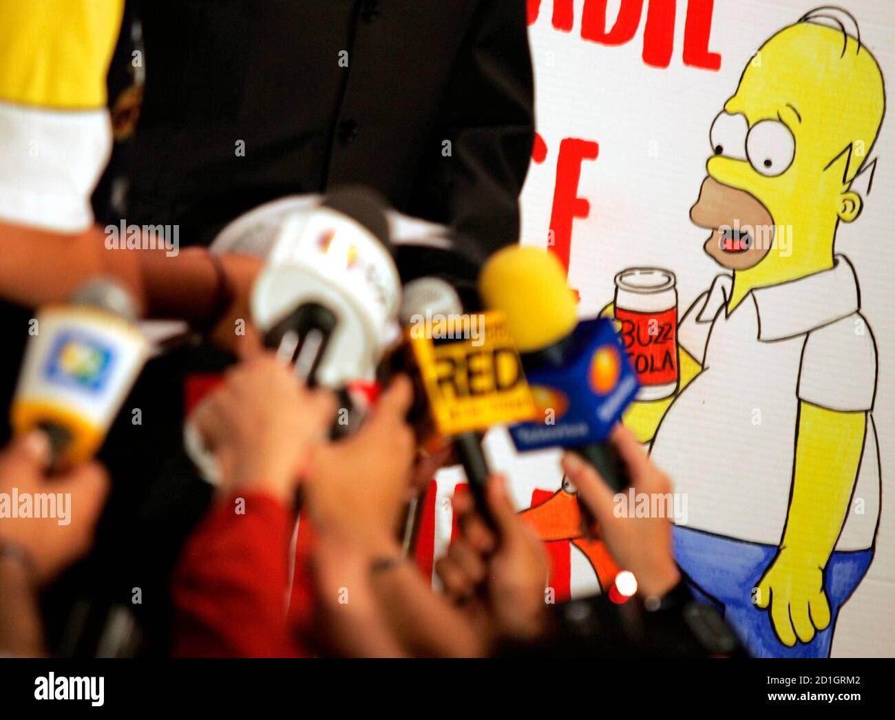 Mexican actors hold up paintings of characters from the Simpsons cartoon as local media hold up microphones during a protest in Mexico City August 3, 2005. The union actors who dub Mexican actors hold up paintings of characters from the Simpsons cartoon as local media hold up microphones during a protest in Mexico City August 3, 2005. The union actors who dub