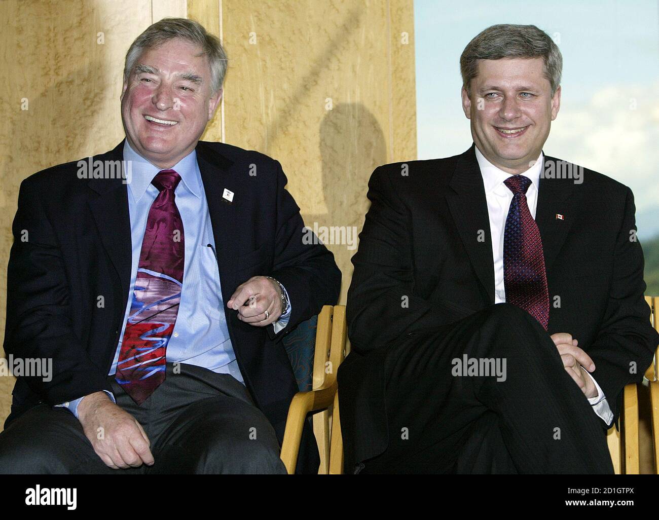 Canadian Prime Minister Stephen Harper (R) and International Trade Minister David Emerson laugh during a news conference in Vancouver, British Columbia August 30, 2006. Harper was in Vancouver to announce an additional 55 million dollars (CDN) ($50 million) in funding for the 2010 Winter Olympic games, local media reported.   REUTERS/Lyle Stafford (CANADA) Stock Photo