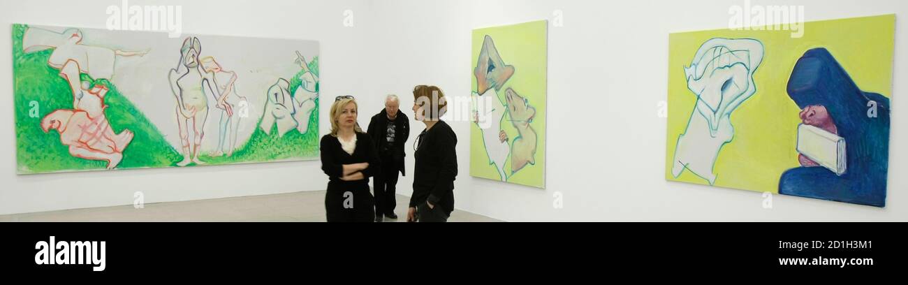 Visitors stand in front of the paintings 'Hochzeitsbild' (wedding picture), 'die Bewunderung' (admiration) and 'Maedchen mit Buecherwurm' (girl with bookworm), L-R, by Austrian artist Maria Lassnig during the opening of an exhibition at Vienna's MUMOK museum February 12, 2009.   REUTERS/Herwig Prammer  (AUSTRIA) Stock Photo