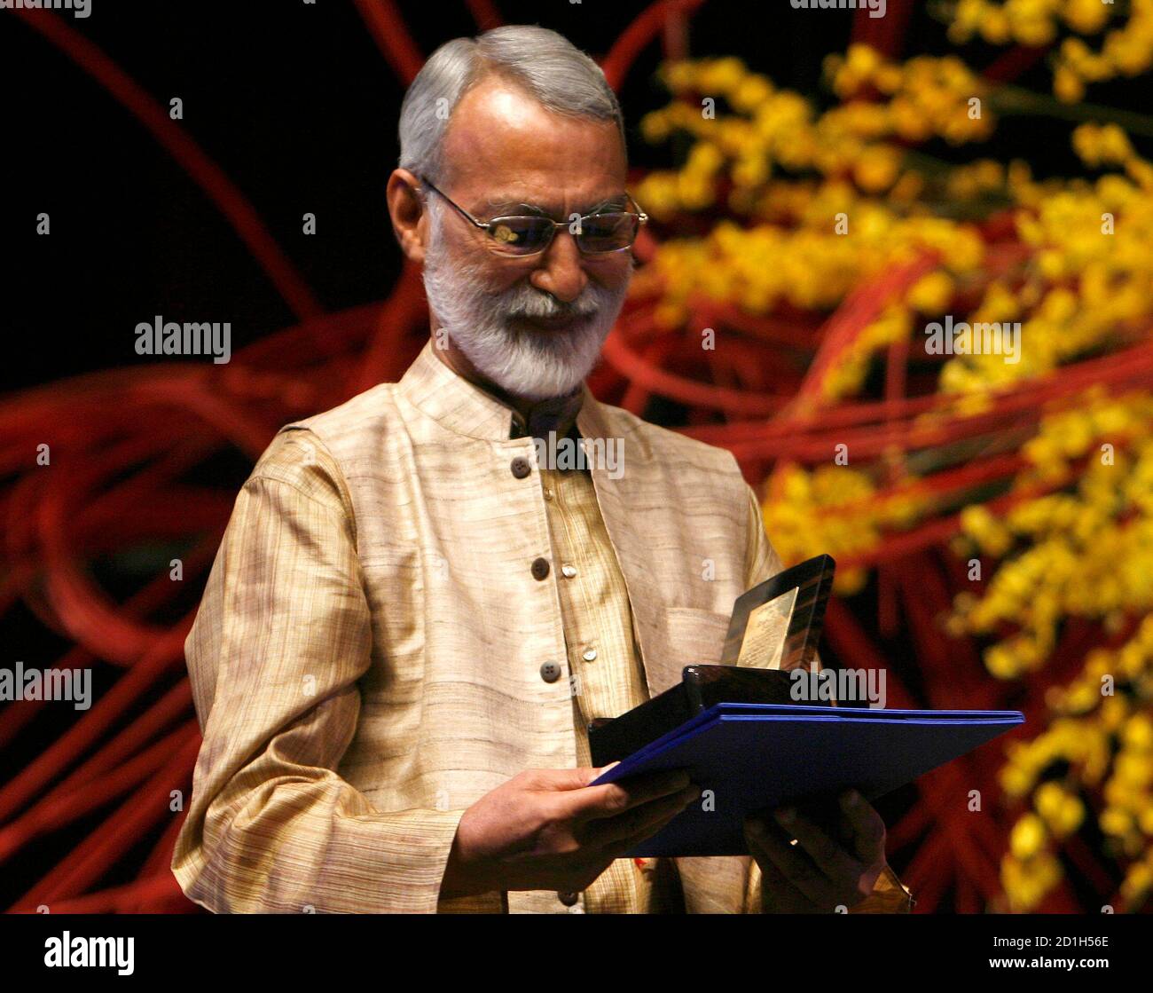 Deep Joshi Of India A 09 Ramon Magsaysay Awardee Asia S Equivalent Of The Nobel Prize Looks At His Medallion And Citation During Awarding Ceremony At The Cultural Center Of The Philippines Ccp