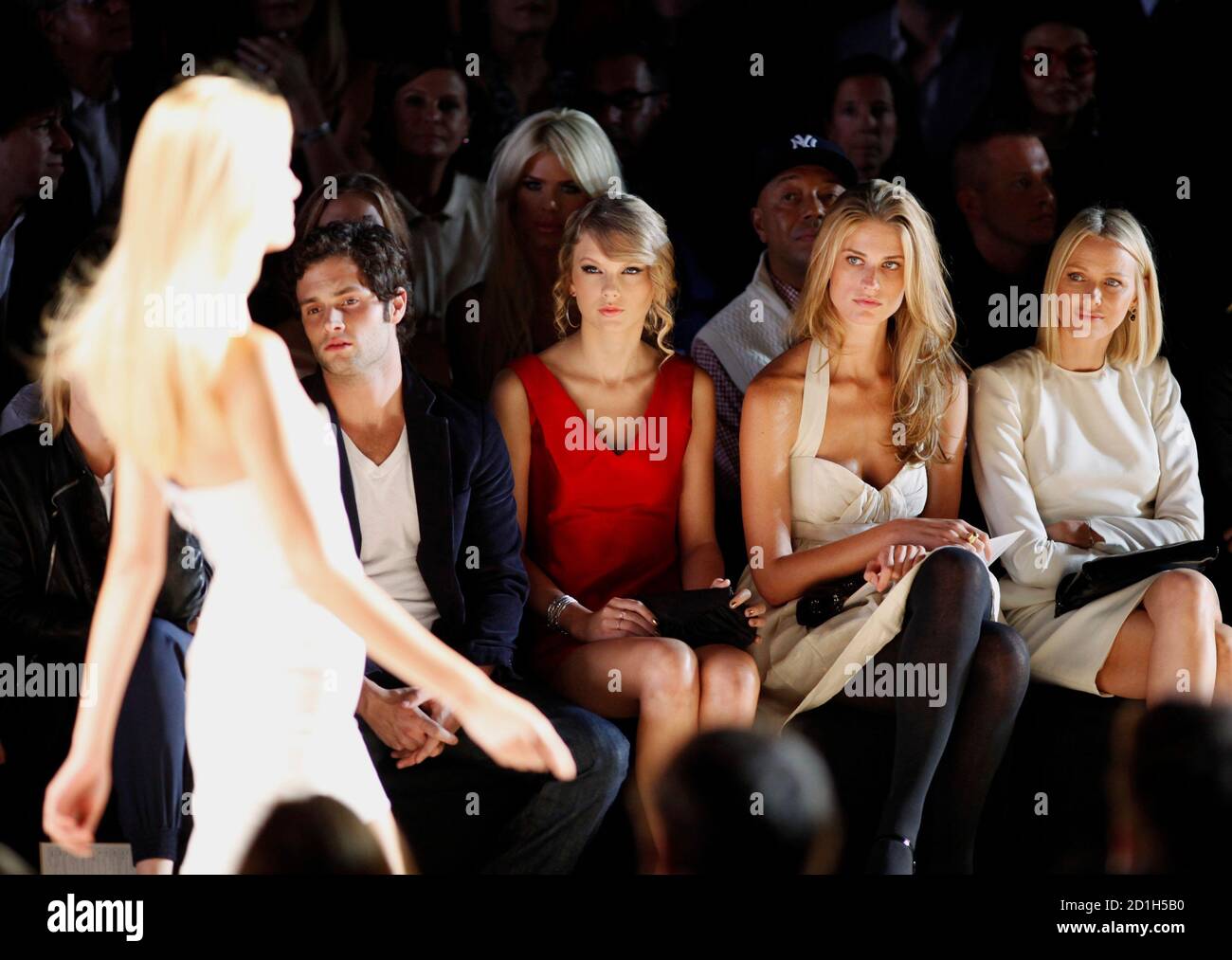 Actor Penn Badgley, singer Taylor Swift, an unidentified guest and actress  Naomi Watts watch the Tommy