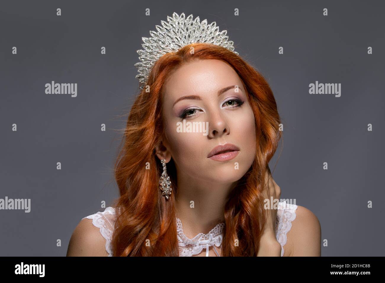 Beauty queen. Woman with crown on head in lace dress posing with