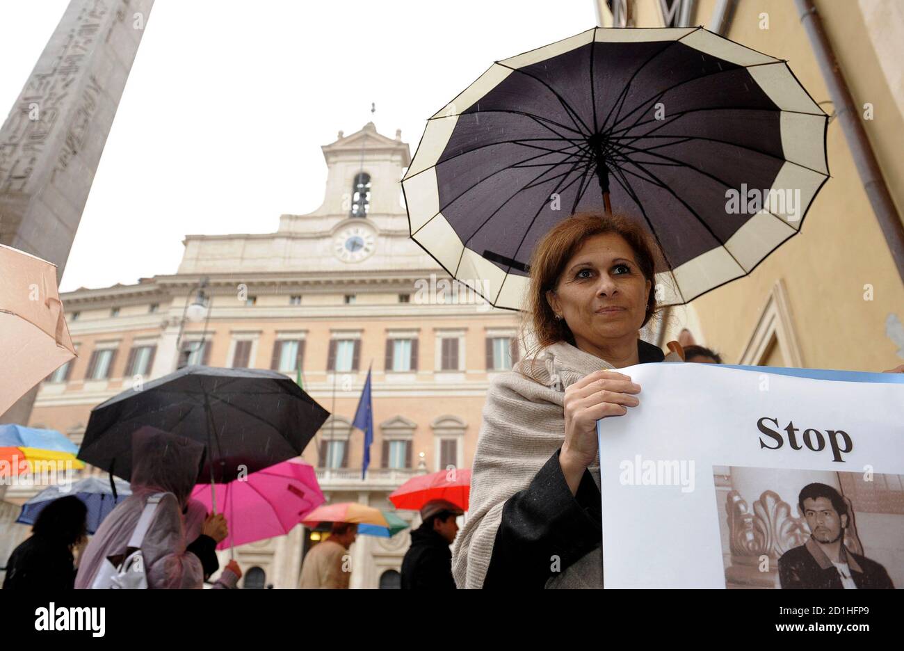 Souad Sbai, a lawmaker from the People of Freedom party, holds a banner during a demonstration for Sayed Perwiz Kambakhsh, an Afghan journalist who was arrested in 2007 after downloading material from the internet relating to the role of women in Islamic societies and given the death sentence for blasphemy, in Rome April 1, 2009. Souad Sbai spent years in Italy defending battered women in the Moroccan immigrant community before the death threats started coming. Now that she's a member of parliament, she wonders if they'll ever stop.      REUTERS/Alessandro Bianchi    (ITALY POLITICS CONFLICT) Stock Photo