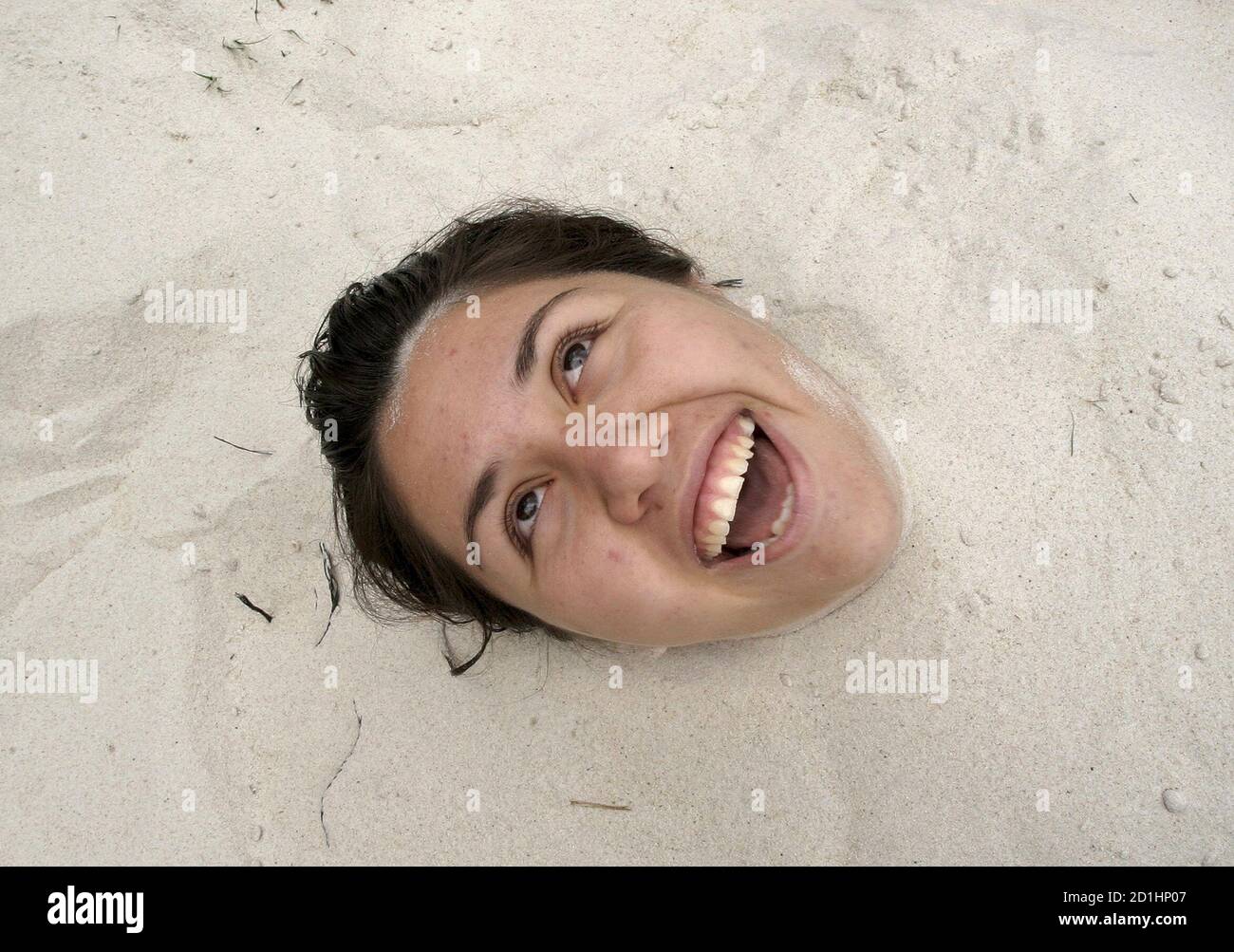 A youth is covered in sand during the opening day of the first of four city beaches in Mexico City April 3, 2007. Mexico City's first beach was already buzzing by mid-afternoon on Tuesday, the official launch day, with paddling pools and volleyball to entertain the throngs. REUTERS/Daniel Aguilar (MEXICO) Stock Photo