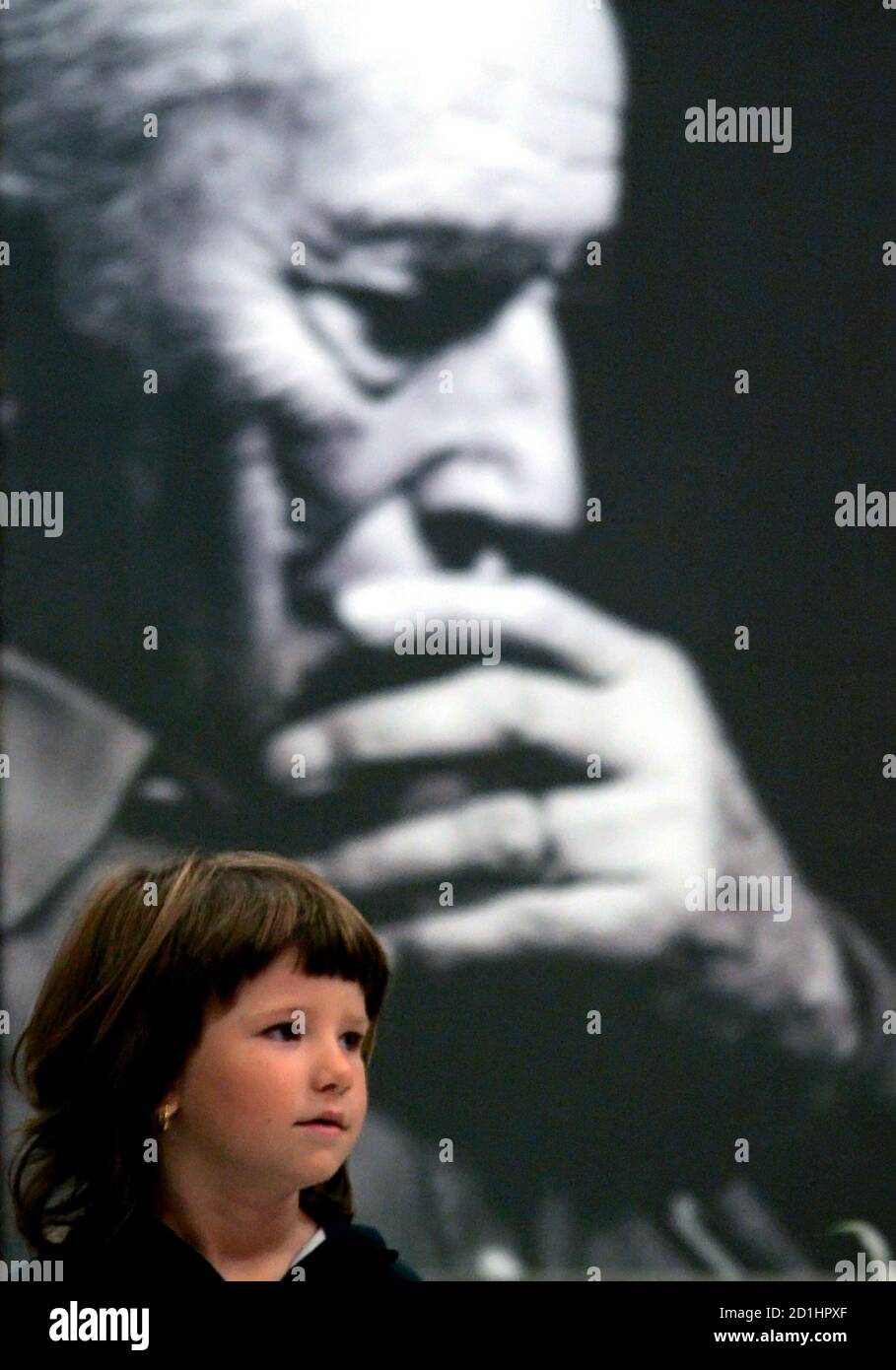 Nausica, the niece of late Italian director Michelangelo Antonioni, looks on near a portrait of her uncle at Rome's City Hall August 1, 2007.  Antonioni, one of Italy's most influential post-war film directors whose portrayals of modern angst and alienation won him a cult following, died July 31, aged 94. REUTERS/Alessandro Bianchi  (ITALY) Stock Photo