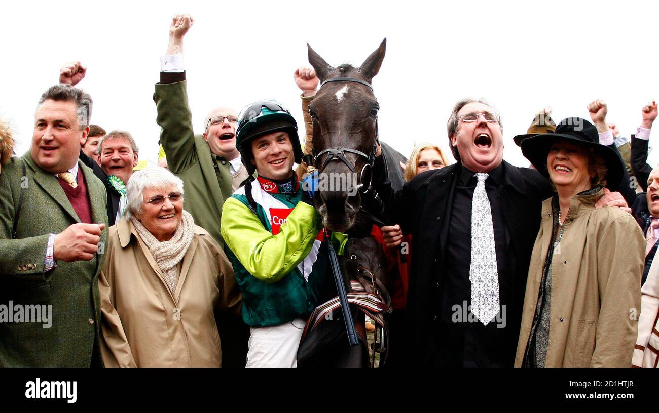 Sam Thomas (3rd L) poses for photographers with his horse Denman after winning the totesport Cheltenham Gold Cup Steeple Chase on the forth day of the Cheltenham Festival horse racing meet in Gloucestershire, western England, March 14, 2008. REUTERS/Eddie Keogh (BRITAIN) Stock Photo