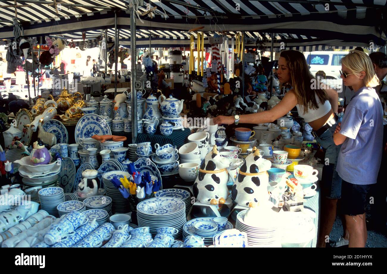Young woman shopping at the crockery stand at the Auer Dult markets, Munich, Germany Stock Photo