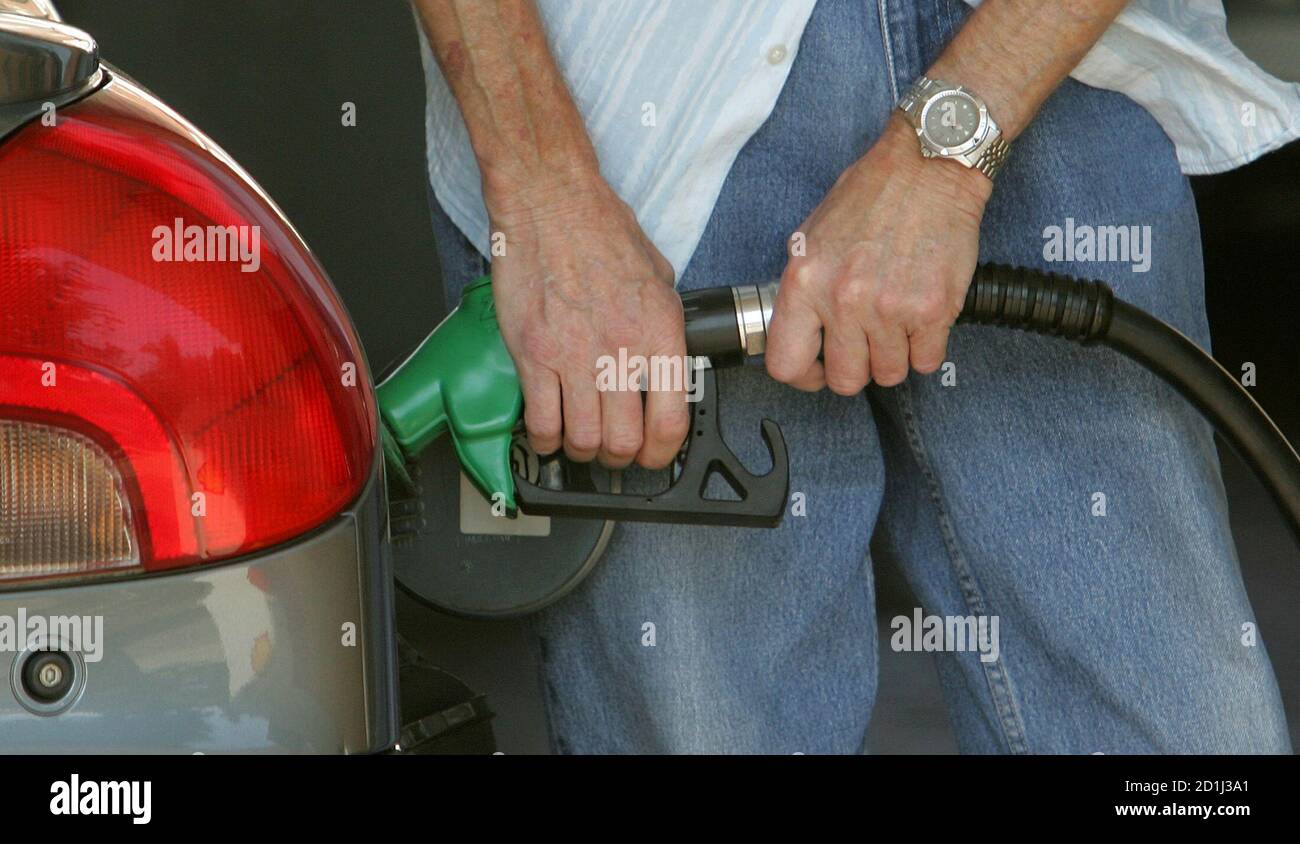 A driver fills up with petrol in Brighton, southern England, September 13, 2005. An expected repeat of protests and blockades at refineries and oil depots by members of Britain's road haulage [industry] over increasing prices of fuel has led to speculation of future shortages. Stock Photo