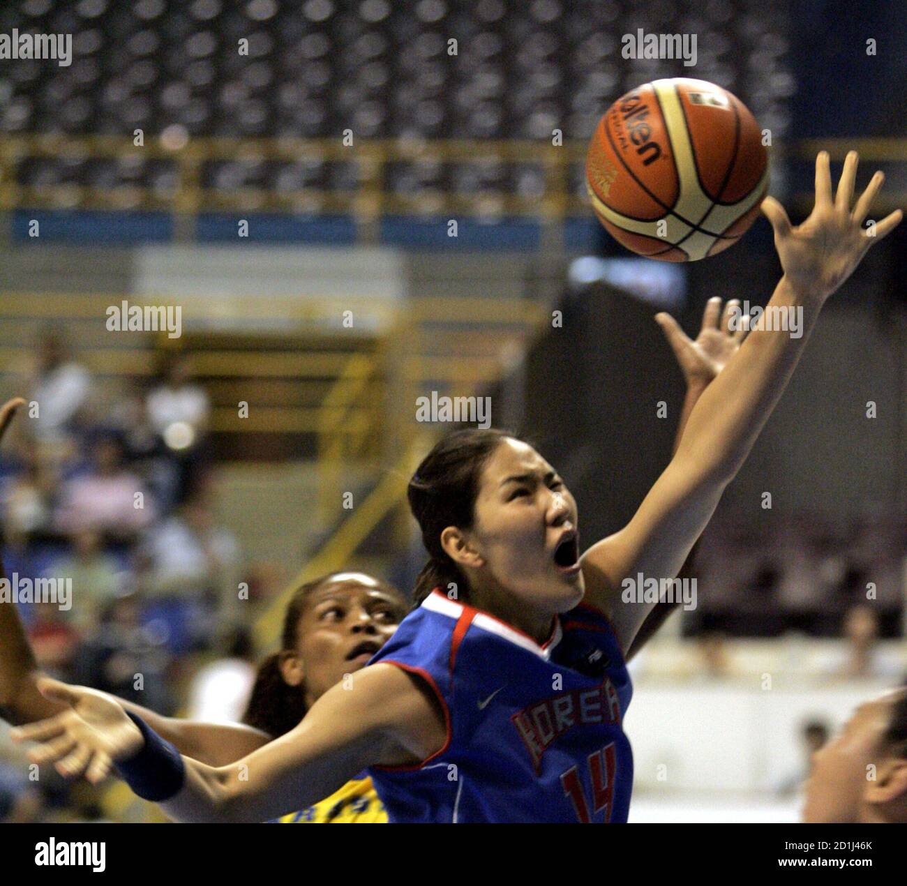 Brazil's Alessandra Oliveria (L) fights with South Korea's Kim Kwe Ryong for the ball during their 15th Women?s World Basketball Championship in Sao Paulo September 13, 2006. REUTERS/Paulo Whitaker  (BRAZIL) Stock Photo