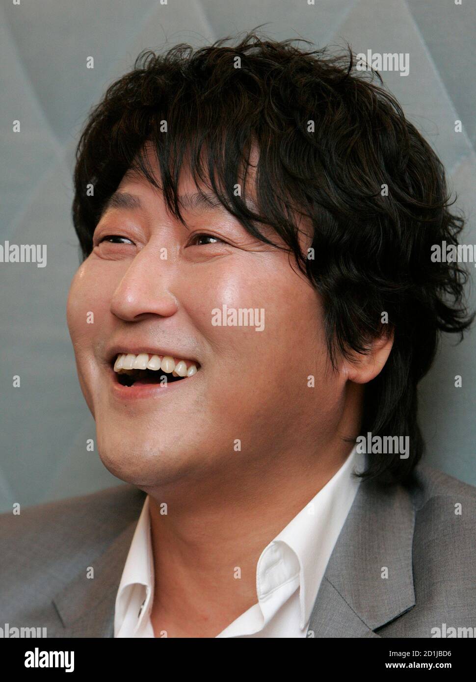 South Korean movie actor Song Kang-ho smiles during an interview with Reuters regarding his new movie 'Thirst', one of the 62nd Cannes Film Festival nominees, in Seoul May 4, 2009. One of South Korea's most bankable stars will return to the red carpet of the Cannes International Film Festival next week with a blood-soaked morality tale of a Catholic priest turned vampire.  Picture taken May 4, 2009.  REUTERS/Jo Yong-Hak (SOUTH KOREA ENTERTAINMENT HEADSHOT SOCIETY) Stock Photo
