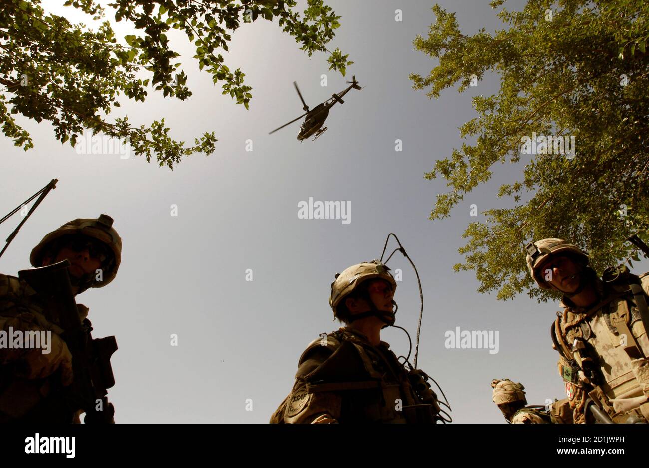 Canadian soldiers from Charles Company of 1st battalion of Royal Canadian Regiment ask for helicopter support during Reed water operation leads by Afghan National Army in Panjwa'i district some 29 kilometers south-west of Kandahar City early May 20, 2010. REUTERS/Nikola Solic (AFGHANISTAN - Tags: MILITARY CONFLICT) Stock Photo