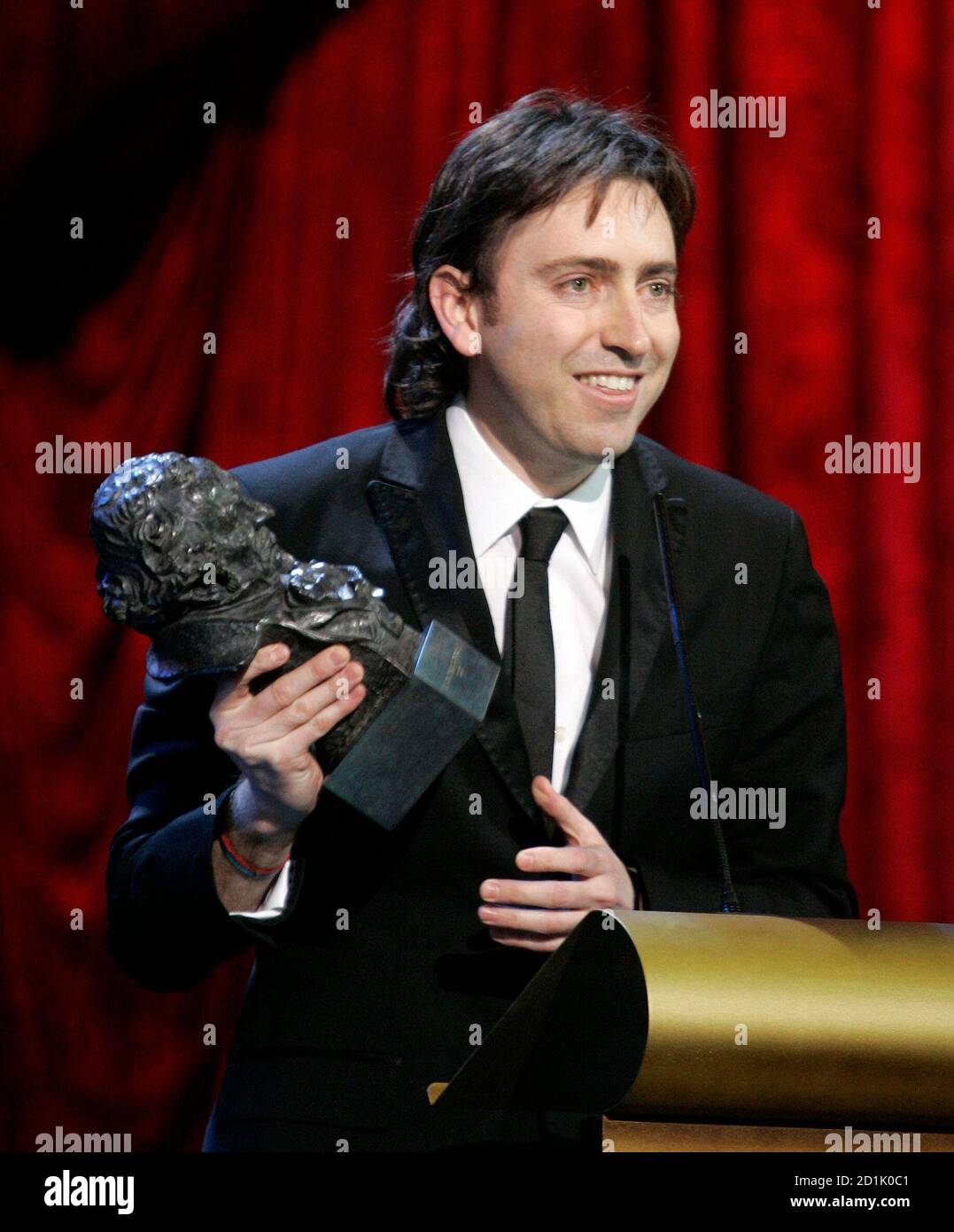 Director Daniel Sanchez Arevalo reacts upon receiving his 'Goya' award during the Spanish Film Academy 'Goya' awards ceremony in Madrid January 28, 2007. Sanchez Arevalo won the Best Upcoming Director award for his movie 'Azul oscuro casi negro'.   REUTERS/Andrea Comas (SPAIN) Stock Photo
