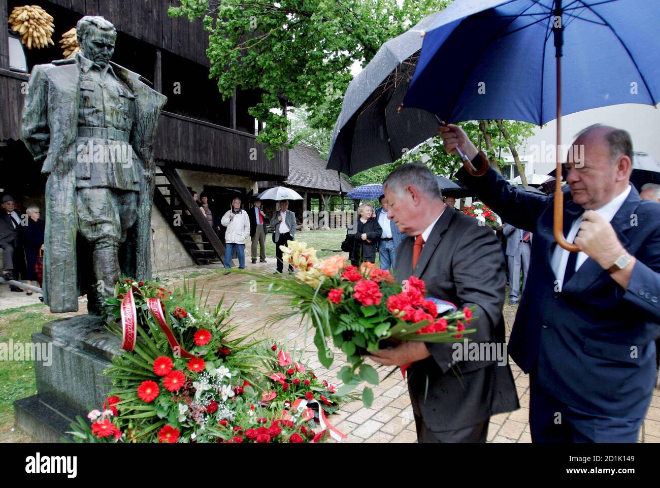 Men place flowers at the statue of Yugoslav wartime partisan leader Josip  Broz Tito at Tito's birthplace in the Croatian village of Kumrovec on the  anniversary of his death May 4, 2007.