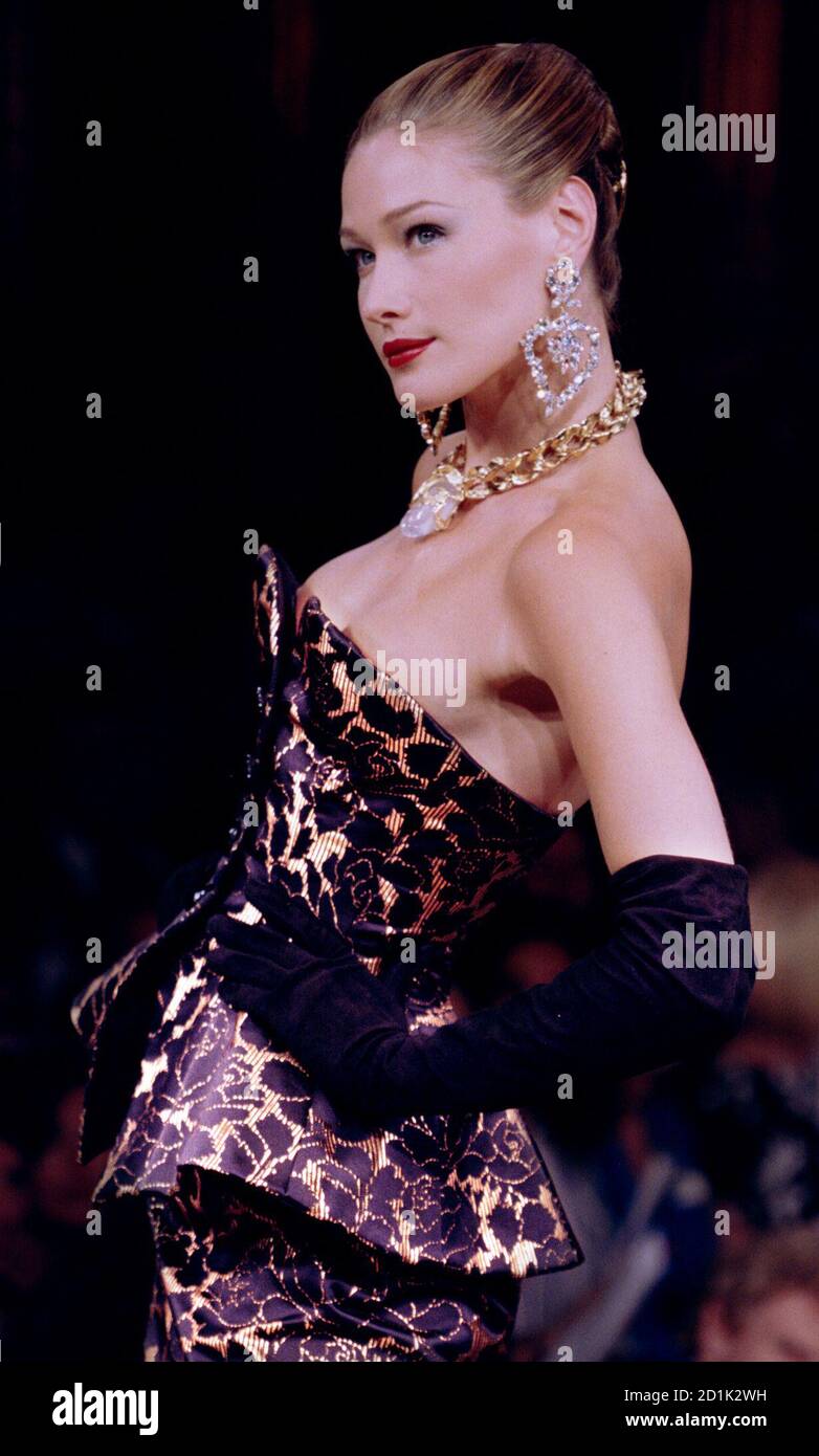 File photo of Italian top model Carla Bruni for French fashion designer  Yves St. Laurent presenting this short black and gold strapless cocktail  dress as part of his Autumn/Winter 1995 High fashion