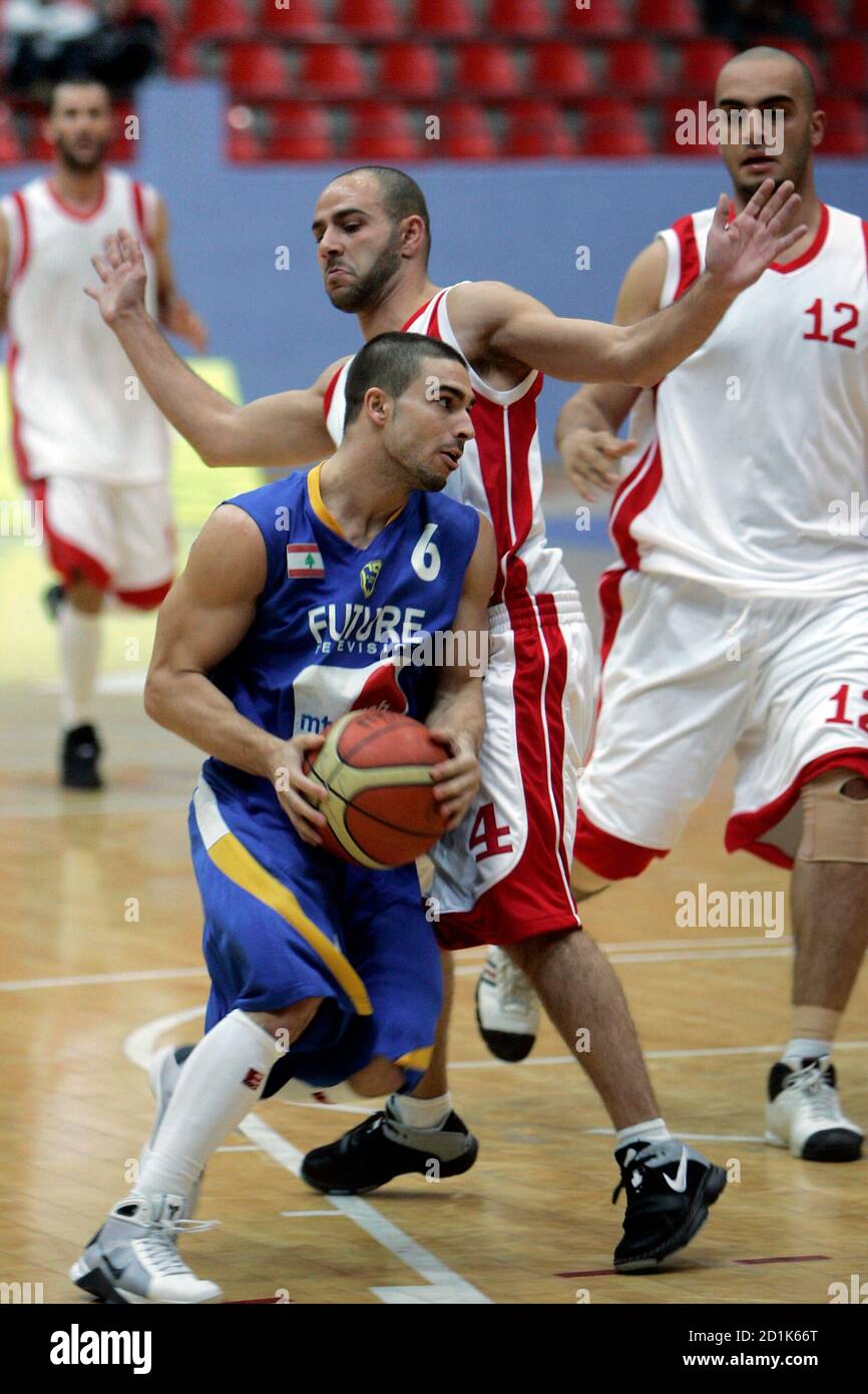 Ali Mahmoud (front) of Lebanon's Al-Riyadi goes to the basket against Loay  Obaid (L) and Ayman Idais (R) of Jordan's Orthodoxi during their West Asian  Clubs Championship basketball game in Amman March