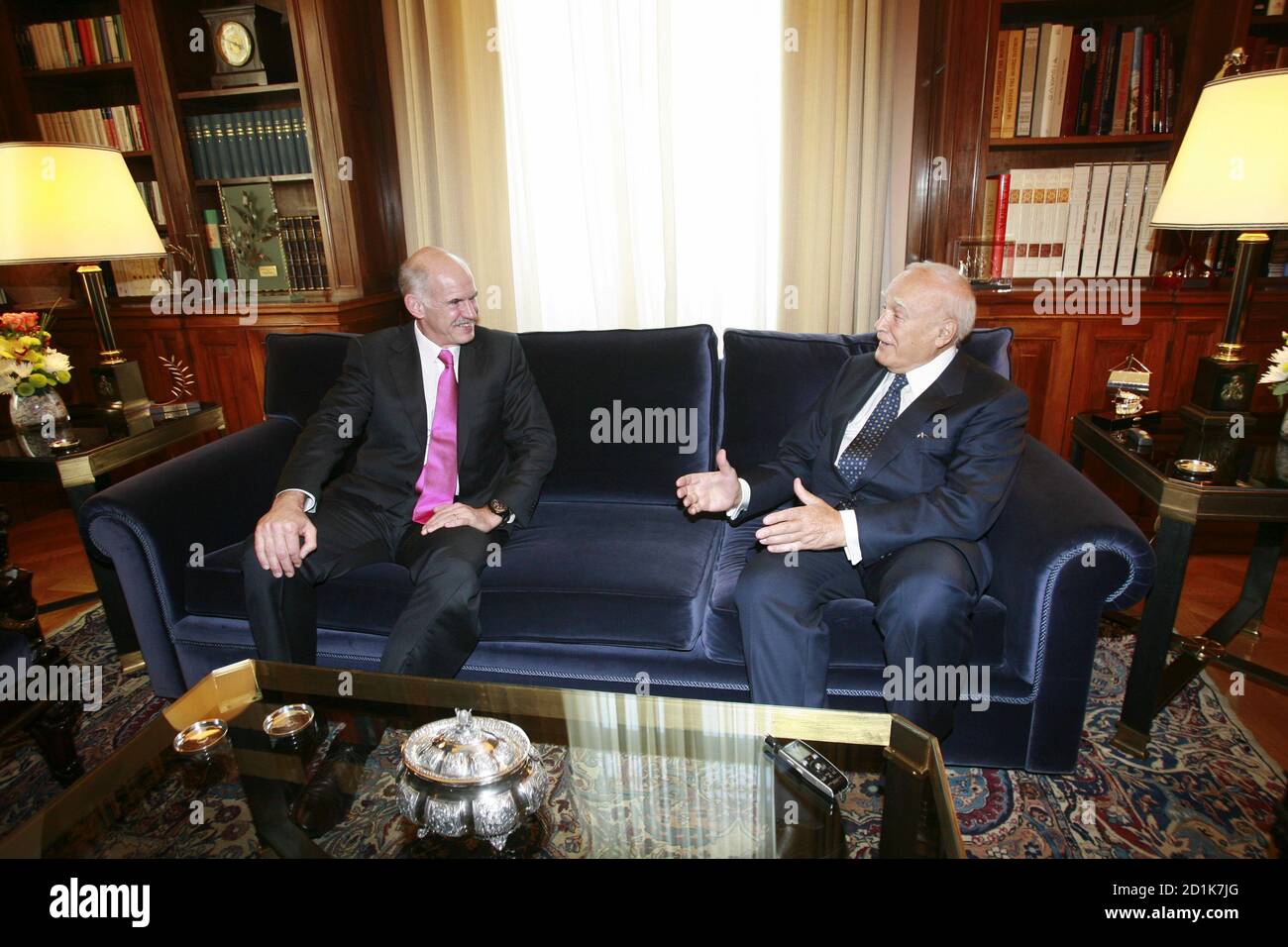 Greece's President Karolos Papoulias (R) talks with the leader of the  PanHellenic Socialist Movement (PASOK) party George Papandreou at the  presidential palace hall in Athens October 5, 2009. Papandreou started work  putting