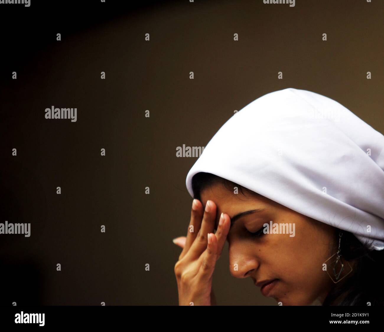 A girl prays at a Parsi temple on the Parsi New Year in Mumbai August 20, 2005. Followers of the Persian prophet Zarathustra, the Parsi community arrived in western India 1200 years ago after they fled Persia following persecution from Arab conquerors. REUTERS/Punit Paranjpe AD/NL Stock Photo