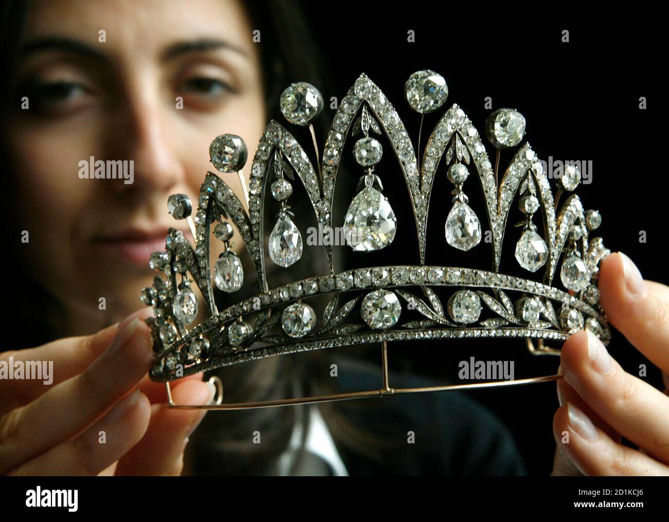 Christie's member of staff Carine Decroi displays an antique diamond tiara  (circa 1890) by Faberge during an auction preview in Geneva May 11, 2007.  This jewel, from the collection of Princess Maria