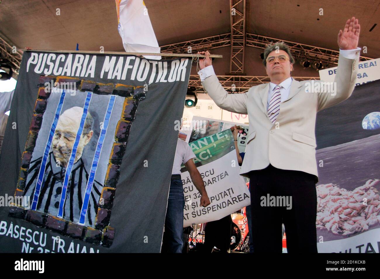 Ultra Nationalist Leader Of Greater Romania Party Corneliu Vadim Tudor Holds A Banner Depicting Romania S Suspended President Traian Basescu In Prison During A Rally Organised By Opponents Of Basescu In Bucharest May 17