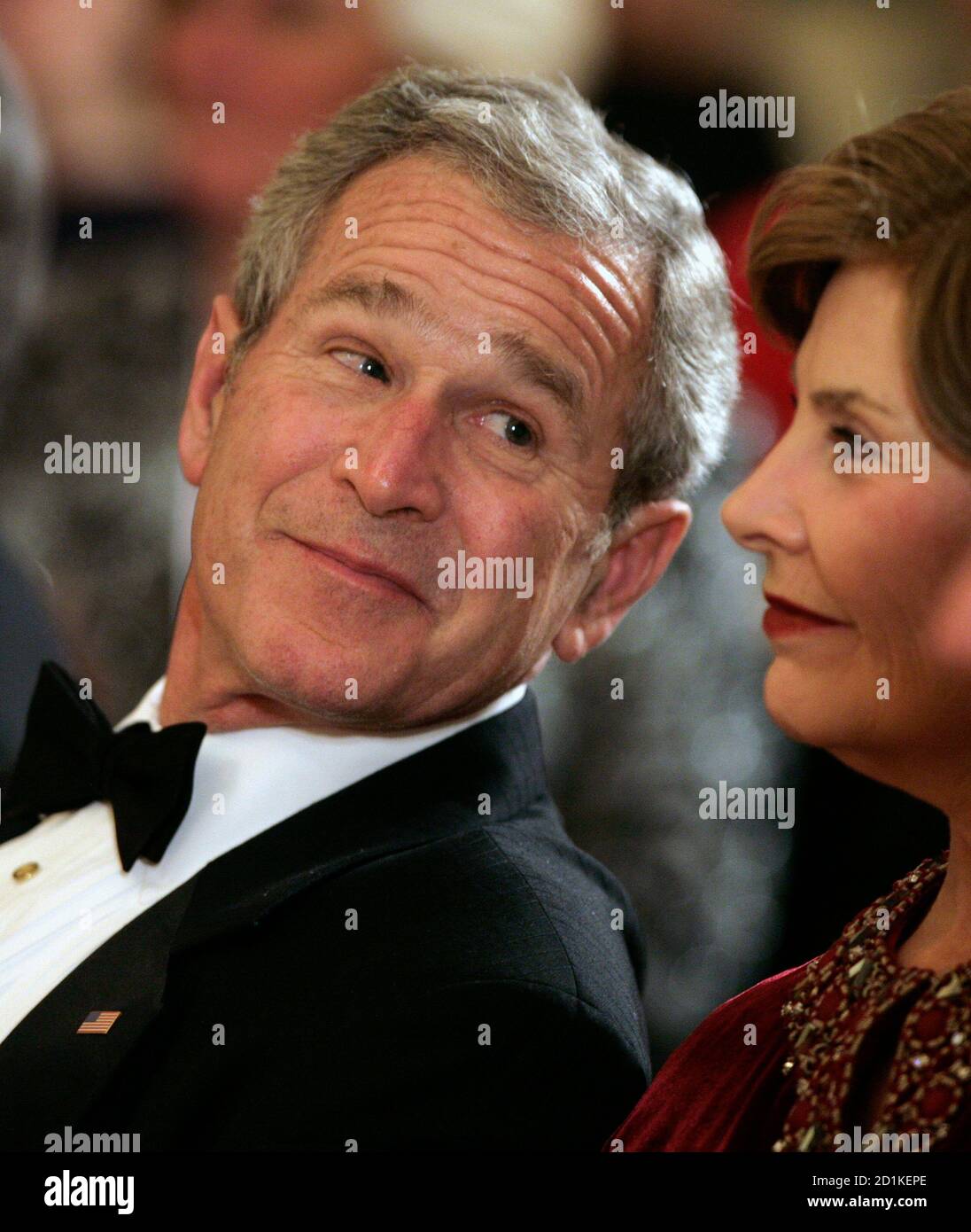 U.S. President George W. Bush looks at first lady Laura Bush as they attend Valentine?s Day Entertainment at the White House in Washington February 14, 2008. REUTERS/Yuri Gripas (UNITED STATES) Stock Photo