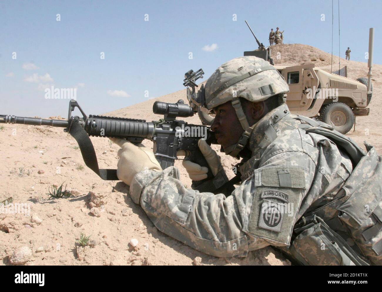 A U.S. soldier takes up a position during a joint raid with Iraqi ...