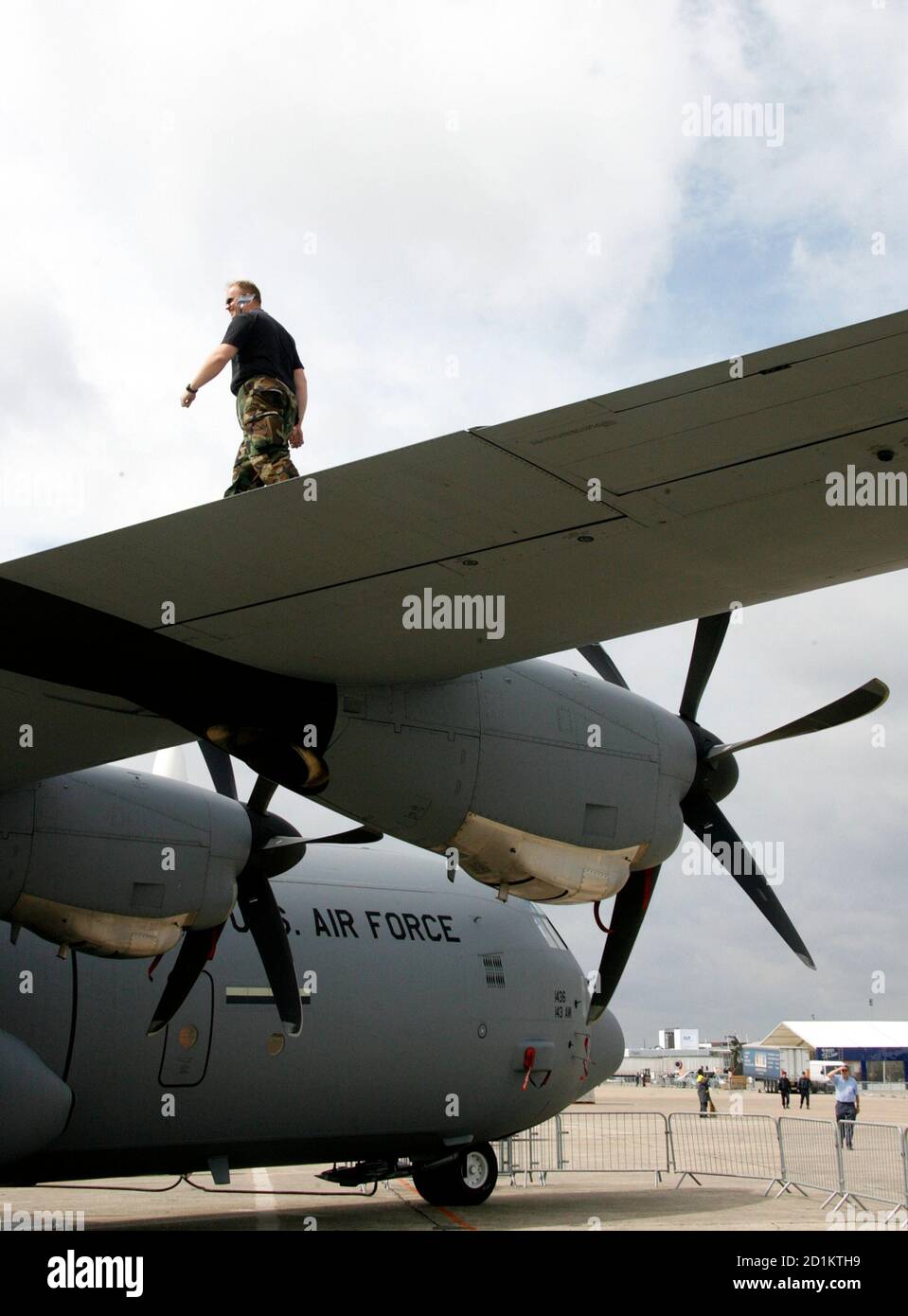A U.S. airman from Rhode Island National Guard - 143rd Airlift Wing, walks on the wing a C-130 J aircraft, three days before the opening of the 47th Paris Air Show at Le Bourget airport near Paris, June 15, 2007.    REUTERS/Pascal Rossignol  (FRANCE) Stock Photo
