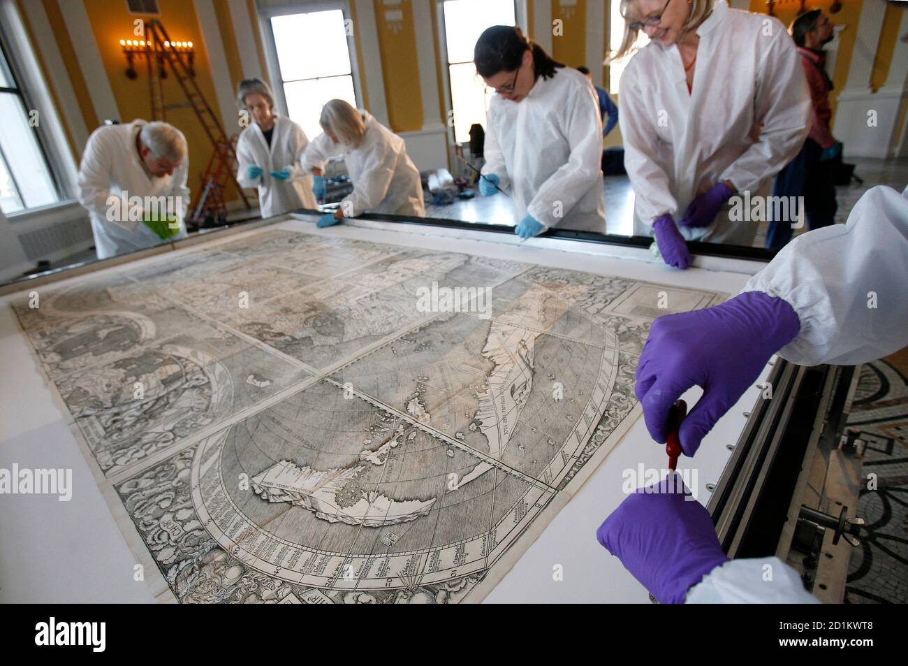 Conservators at the Library of Congress screw down the map that first used the name America as it is prepared for its encasement in Washington December 3, 2007. The 500-year-old map, created by German monk Martin Waldseemuller, is the only known surviving copy and was purchased for $10 million in 2003.    REUTERS/Jim Young   (UNITED STATES) Stock Photo