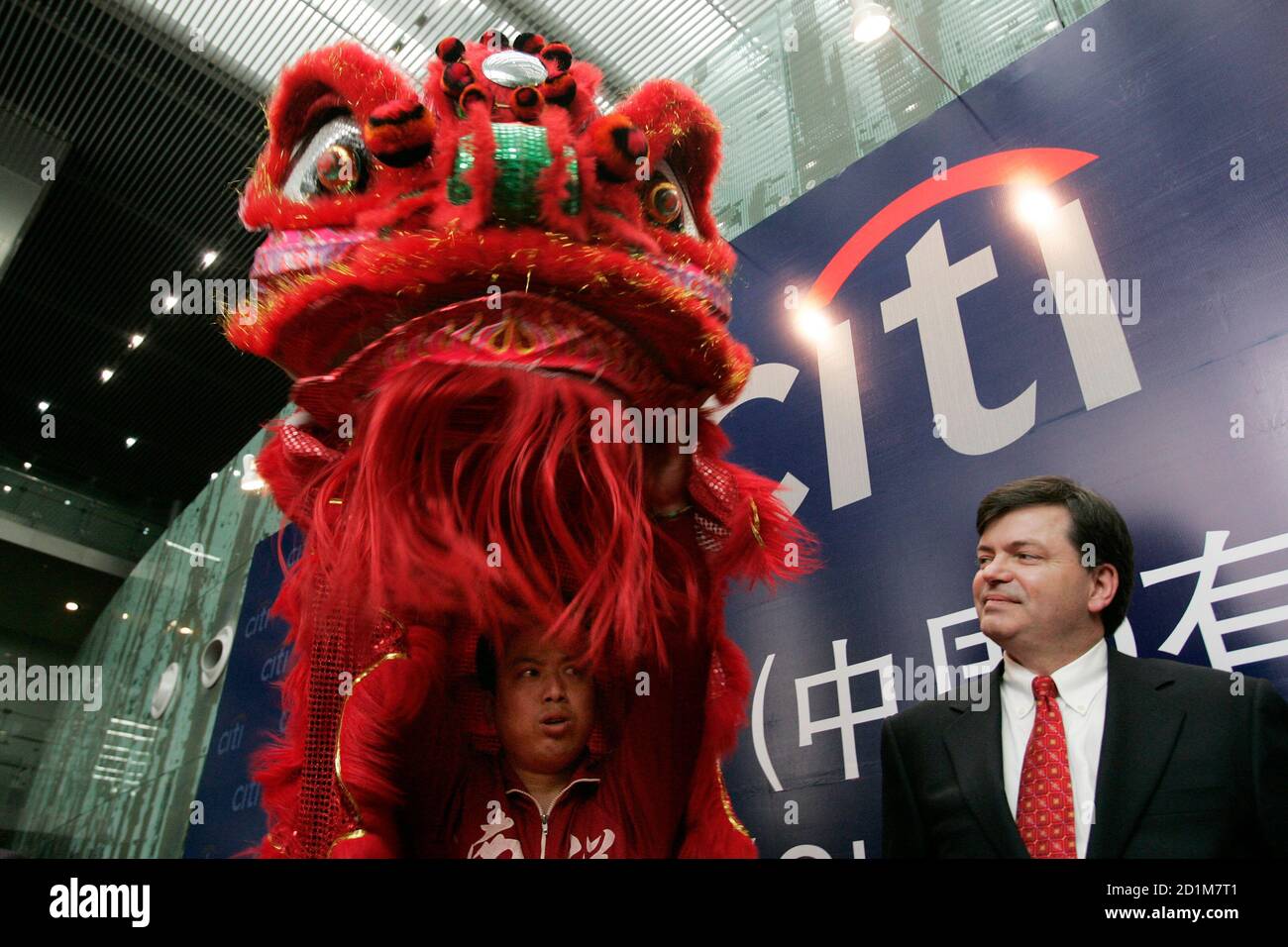 Richard Stanley (R), chairman of Citibank (China) Co. Ltd., enjoys a performance at a ceremony for its official launch in China as a locally incorporated bank, in Shanghai April 2, 2007. Citigroup Inc. said on Monday that it plans to issue cash payment card for its individual clients in China after the world's largest financial services provider launched its local incorporation there.    REUTERS/Aly Song (CHINA) Stock Photo