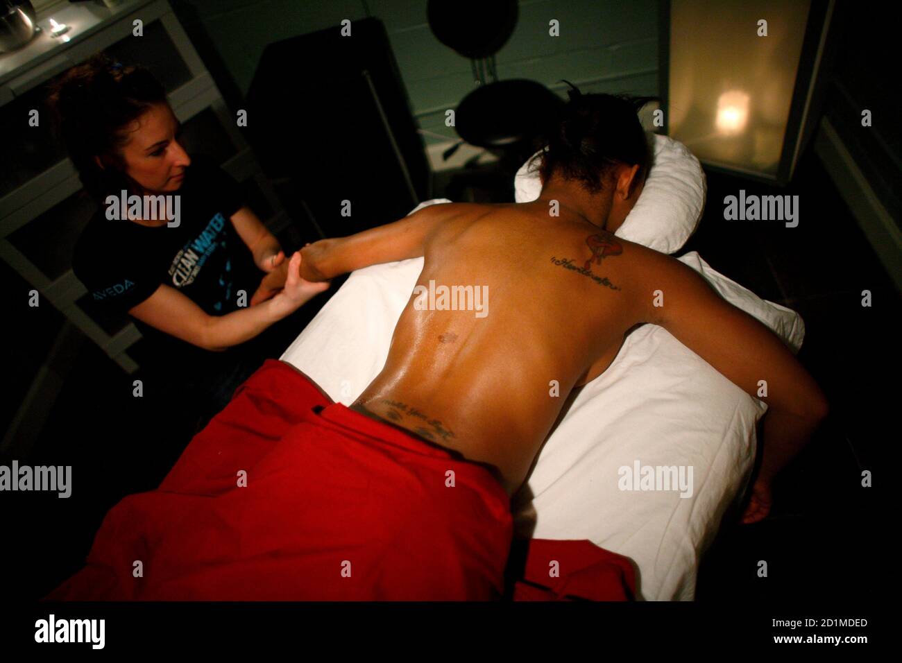 Flirty Girl Fitness member Porscha Williams receives an Aroma Body Wrap  from massage therapist Toni Chciuk at Asili Chi salon in Chicago March 11,  2009. As the economy struggles, the club has