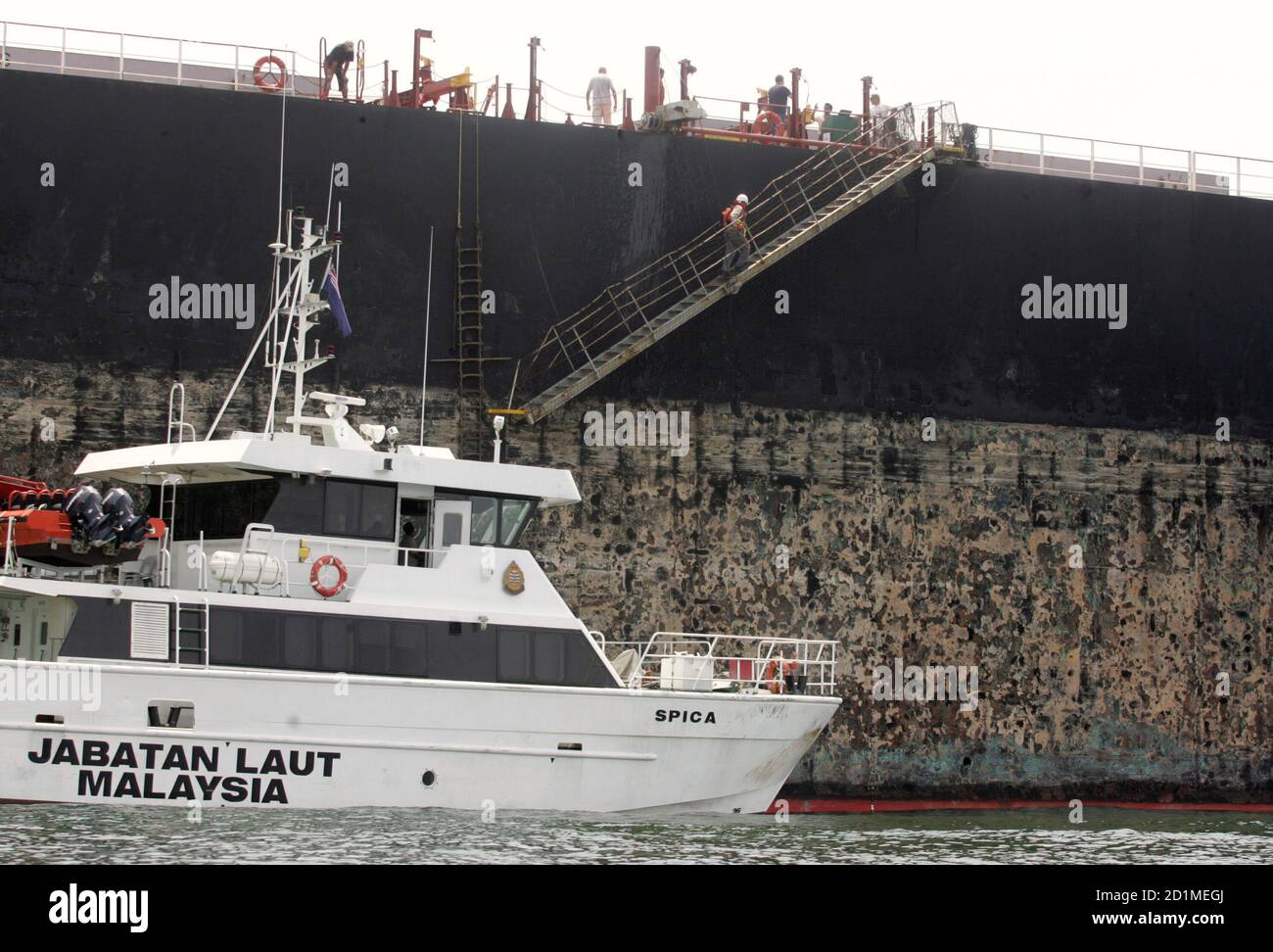 A Malaysian maritime personnel climbs a gangway of the Ostende Max