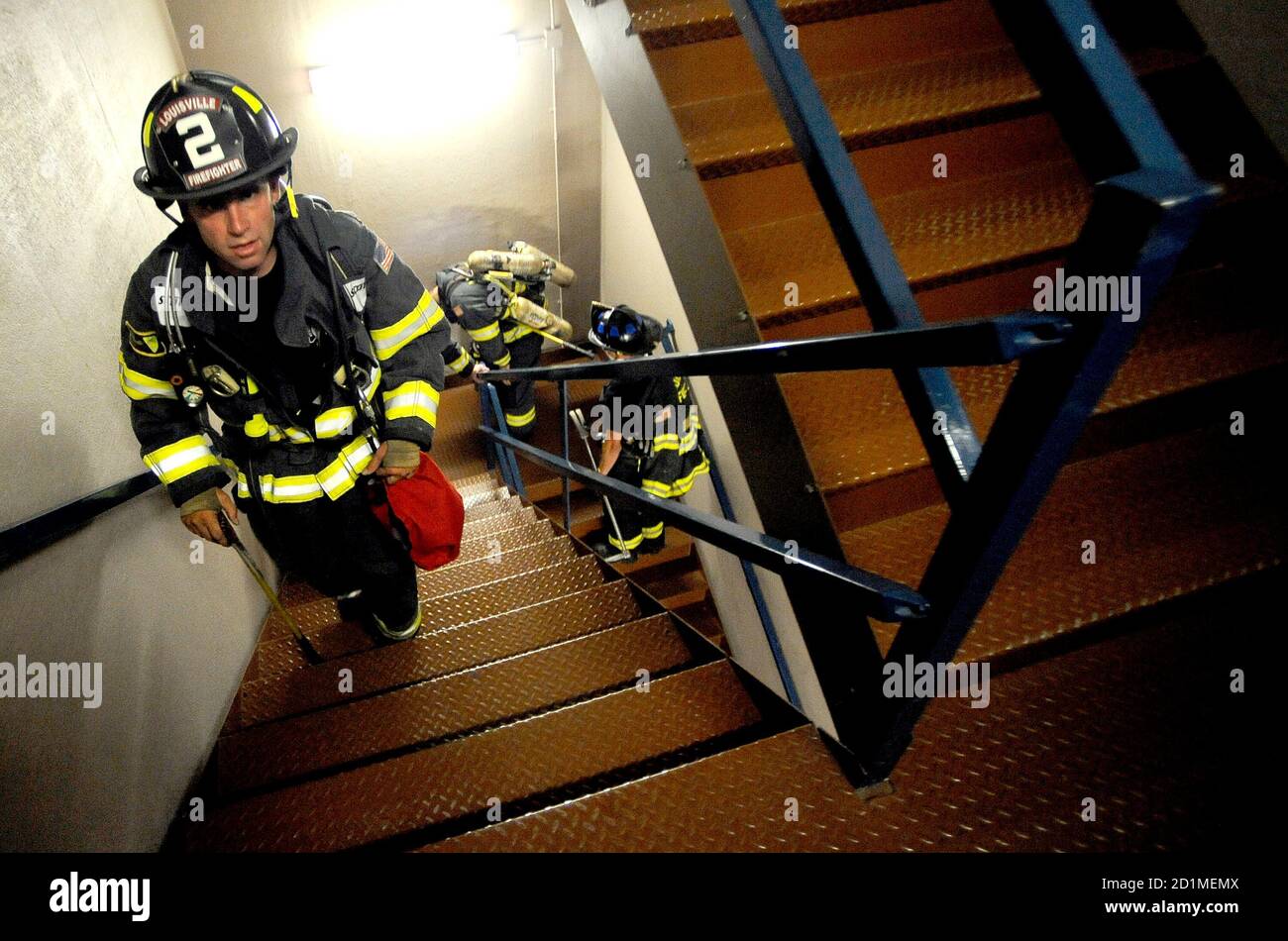 Eric Williams, with the Louisville Fire Department, trudges up the stairs for the 9/11 Memorial Stair Climb at the Qwest Building in Denver, Colorado September 11, 2009. Some 343 firefighters from five states climbed the 55 stories of the Qwest building twice for a total of 110 stories in remembrance of the firefighters killed in the World Trade Center attack September 11, 2001. REUTERS/Mark Leffingwell (UNITED STATES POLITICS ANNIVERSARY) Stock Photo