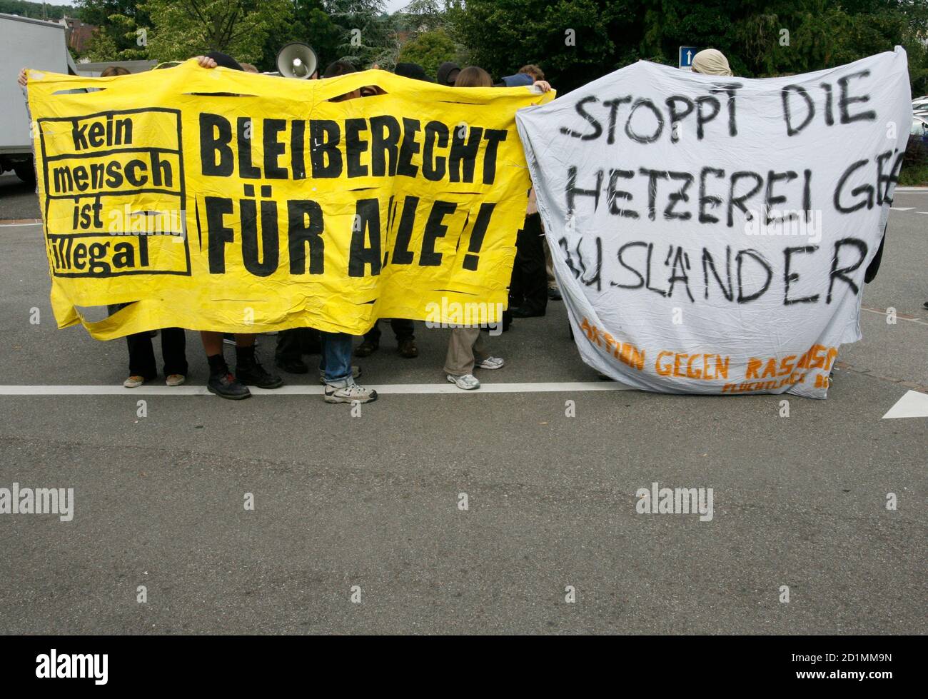 Protesters demonstrate in front of the Swiss People's Party congress in Liestal June 30, 2007. The banner reads 'Bleiberecht fuer alle' (right of abode for all) and 'Stopp die Hetzerei gegen Auslaender' (stop the hurry against foreigners).  REUTERS/Ruben Sprich (SWITZERLAND) Stock Photo