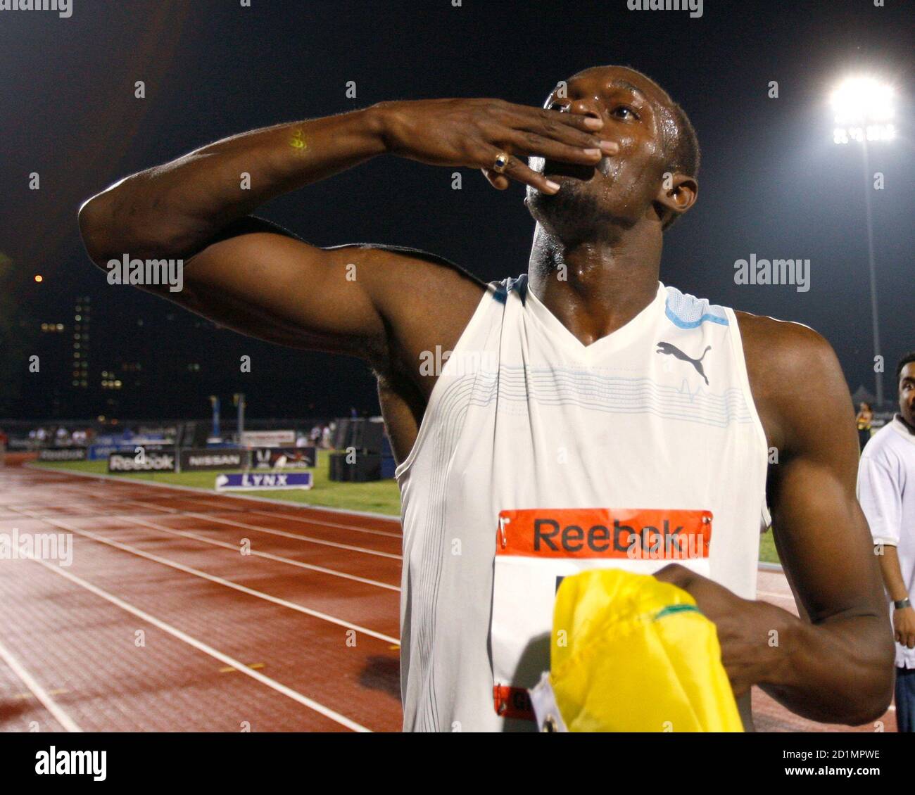 Usain Bolt of Jamaica blows a kiss to the crowd as he celebrates setting a  new world record in the men's 100 meters race at the Reebok Grand Prix  athletics meet in