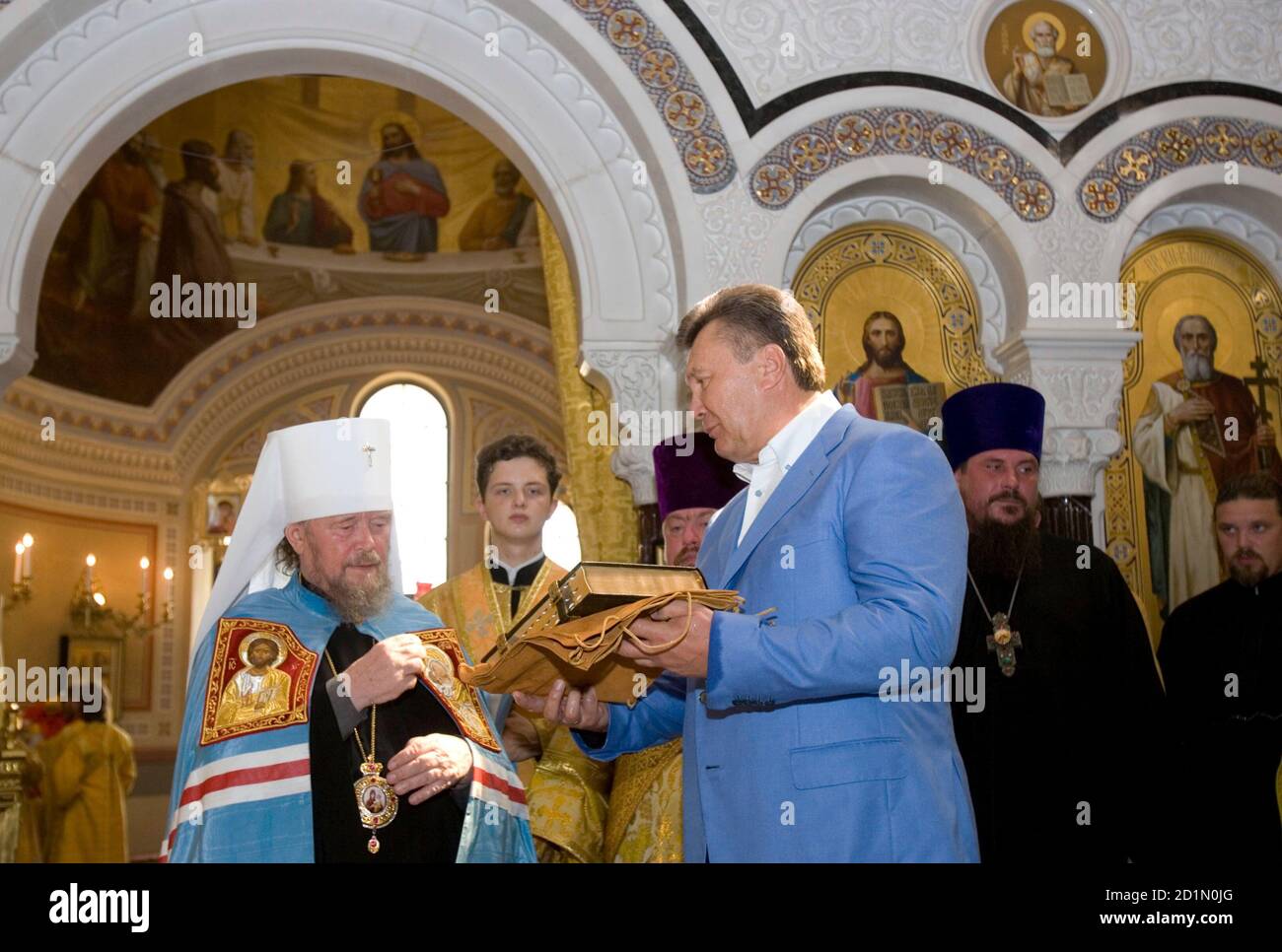 Ukraine's President Viktor Yanukovich (centre R) attends a religious service marking his country's adoption of Christianity, in the town of Khersones July 28, 2010. Ukraine and Russia today marked their official adoption of Christianity, which took place in Kiev, the capital of Kyivan Rus, by its grand prince Vladimir I in 988.  REUTERS/Mykhailo Markiv/Pool  (UKRAINE - Tags: POLITICS RELIGION ANNIVERSARY) Stock Photo