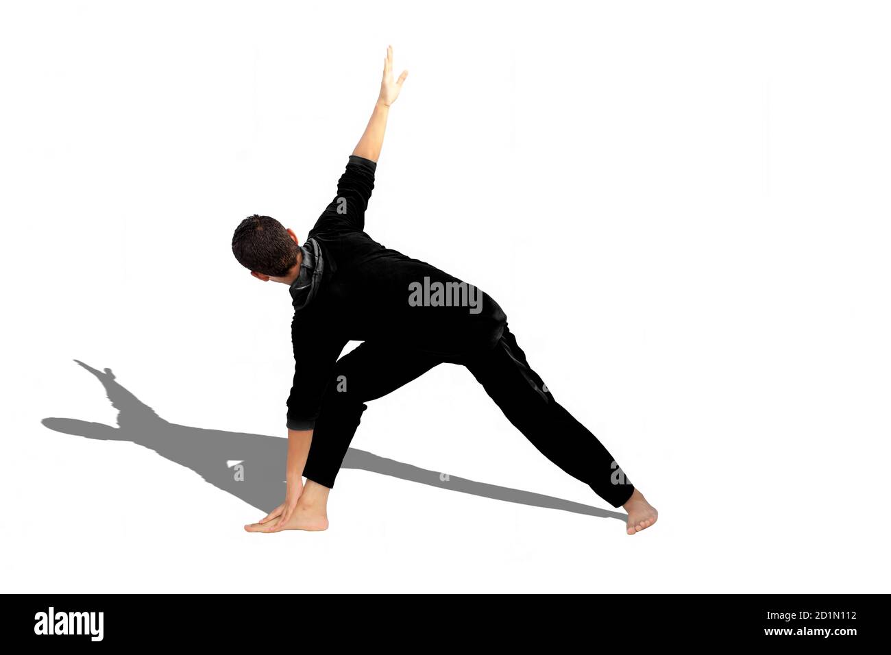 Full-length shot of male teenager practicing Revolved Yoga Pose or Revolved Triangle Yoga Pose or Parivrtta Trikonasana isolated on white background. Stock Photo