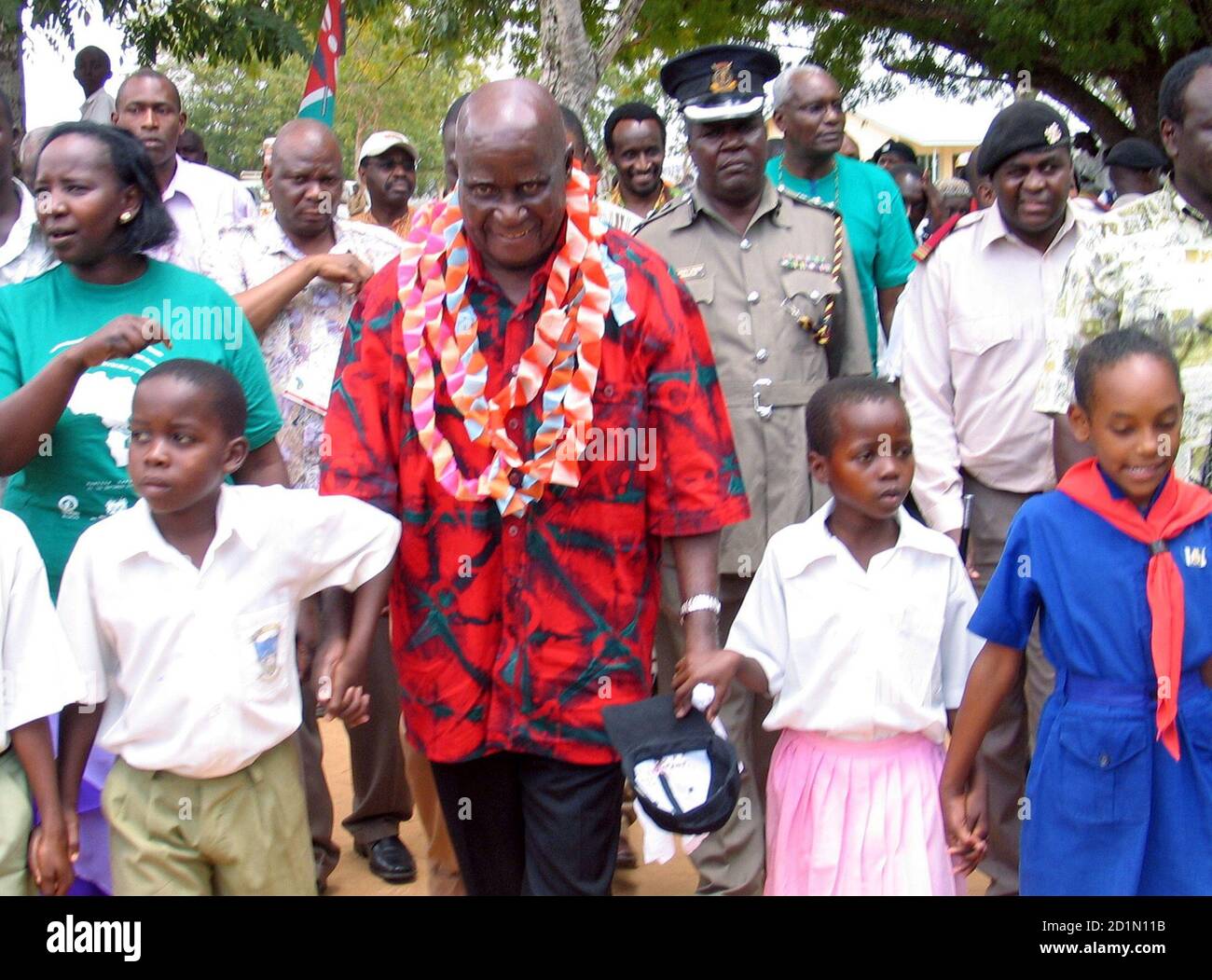 Former Zambian president Kenneth Kaunda (C) walks with children in Ganze village in the Kilifi district before the opening of the second eastern and southern Africa conference on Universal Birth Registration at the Whitesands hotel near Mombasa on the Kenyan coast, 500 km (307 miles) southeast of Nairobi September 26, 2005. The five-day meeting, which is organised by UNICEF and Plan International, is attended by ministers, non-governmental organisations and U.N. agencies from African countries and aims at scaling up birth registration of children in Africa. REUTERS/Joseph Okanga Stock Photo