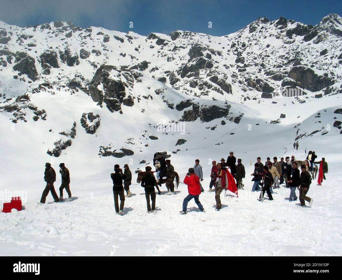 Indian tourists walk on snow at the 4,310 metre high Nathu-la pass on the country's north-eastern border with China in this April 9, 2005 file photo. Just a few yards away bulldozers on both sides of the frontline are building not fortifications but a road, to connect India and China and reopen a historic trade route. New Delhi and Beijing plan to reopen the Nathu-la pass in June after more than 40 years, a potent symbol of rapprochement between Asian giants who fought a Himalayan war in 1962. Picture taken April 9, 2005.  To match feature INDIA CHINA TRADE. REUTERS/Rupak De Chowdhuri/Files (I Stock Photo