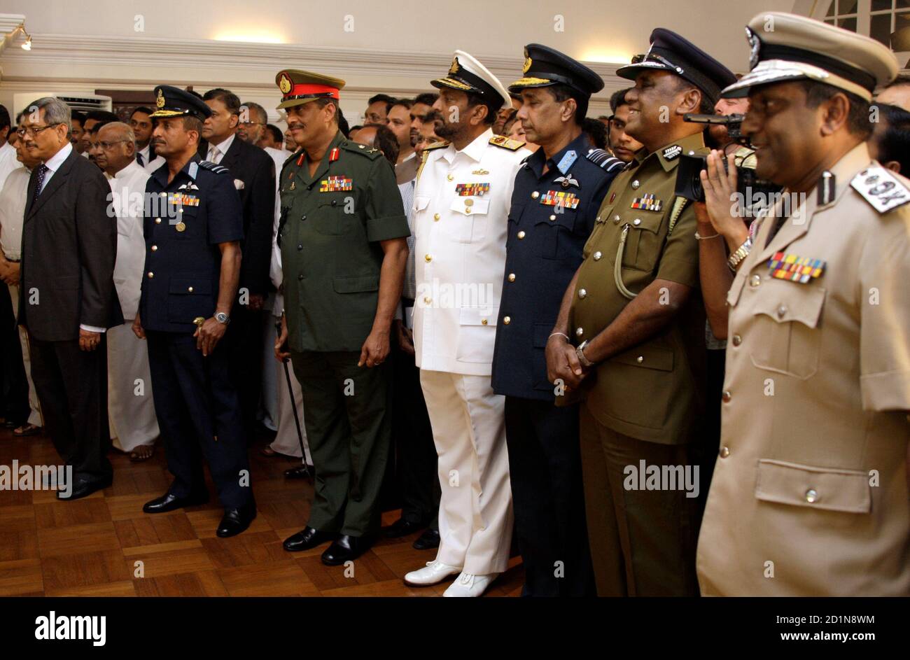 gotabaya-rajapaksa-l-sri-lankas-president-mahinda-rajapaksas-brother-and-the-defence-secretary-stands-with-chief-of-defence-staff-donald-perera-2nd-l-army-commander-lieutenant-general-sarath-fonseka-3rd-l-the-chief-of-the-navy-wasantha-karannagoda-4th-l-air-force-chief-roshan-goonatilake-5th-l-and-the-heads-of-the-sri-lankan-police-force-before-a-meeting-to-discuss-the-end-of-the-25-year-civil-war-at-the-presidents-residence-in-central-colombo-may-18-2009-sri-lankan-troops-won-the-final-battle-in-the-civil-war-with-the-tamil-tiger-separatists-on-monday-putting-the-entire-n-2D1N8WM.jpg