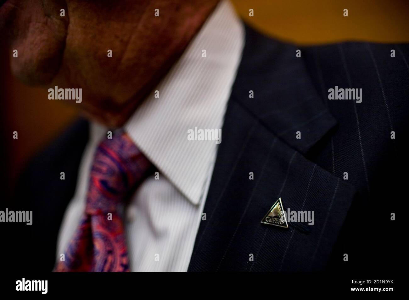 A Calpers employee wears a Calpers pin at their headquarters in Sacramento, California October 21, 2009. Calpers, the largest U.S. public pension fund, manages retirement benefits for more than 1.6 million people, with assets comparable in value to the entire GDP of Israel. The Calpers investment portfolio had a historic drop in value, going from a peak of $250 billion in the fall of 2007 to $167 billion in March 2009 Ñ a loss of about a third during that period. It is now around $200 billion. REUTERS/Max Whittaker (UNITED STATES) Stock Photo