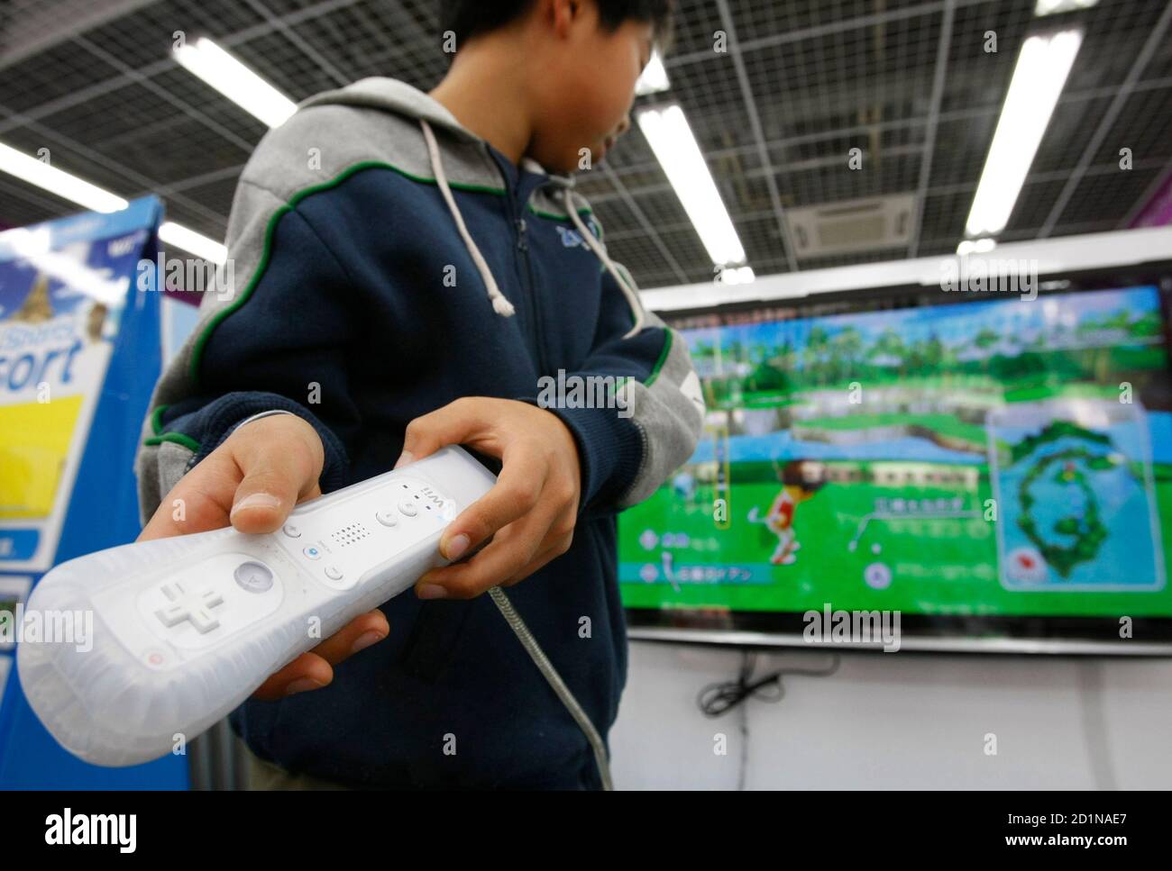 A boy plays Nintendo Co's Wii game console at a Yamada Denki electronics  retail store in Tokyo January 5, 2010. Japan's Nintendo Co Ltd said sales  of its Wii video game console