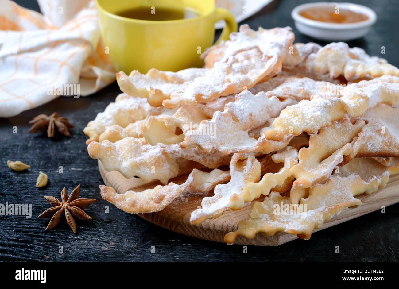 Brushwood crispy deep fried cookies in powdered sugar with tea and