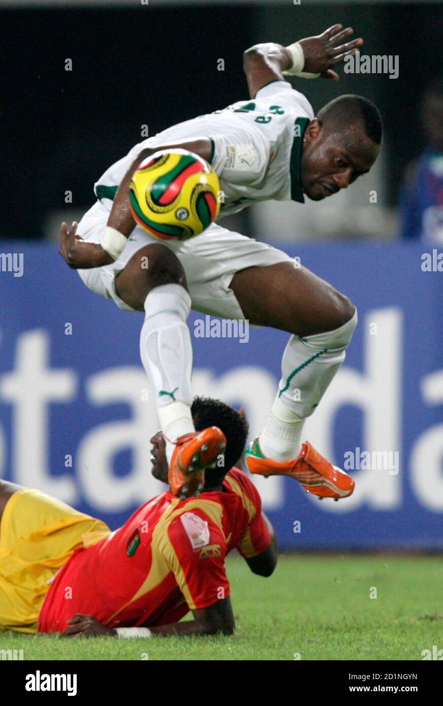 Ivory Coast's Didier Zokora (top) challenges Guinea's Mohamed Sacko during their  African Nations Cup quarter-final soccer match in Sekondi February 3, 2008. REUTERS/Siphiwe Sibeko (GHANA) Stock Photo