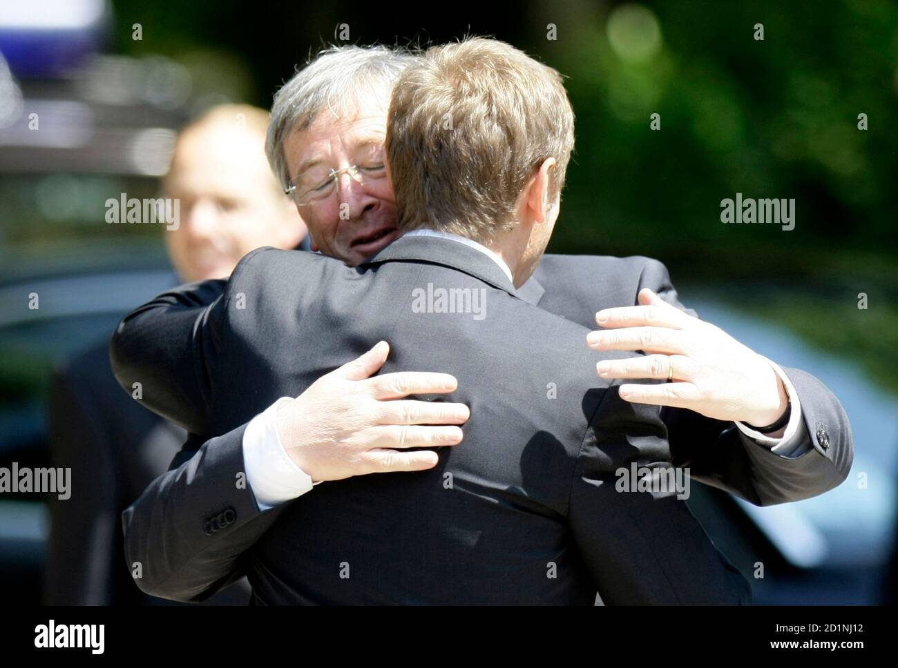 Polish Prime Minister Donald Tusk (R) embraces Luxembourg's Prime Minister Jean-Claude Juncker as they meet at the Palac na Wodzie in Lazienki Park in Warsaw June 10, 2008. REUTERS/Peter Andrews (POLAND) Stock Photo