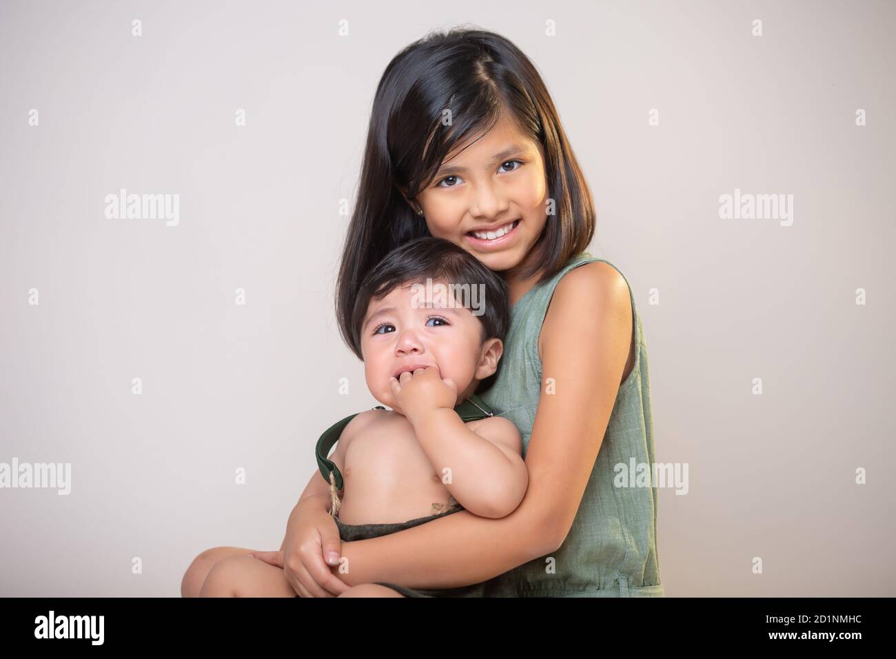 Mexican siblings smiling and cryingisolated Stock Photo