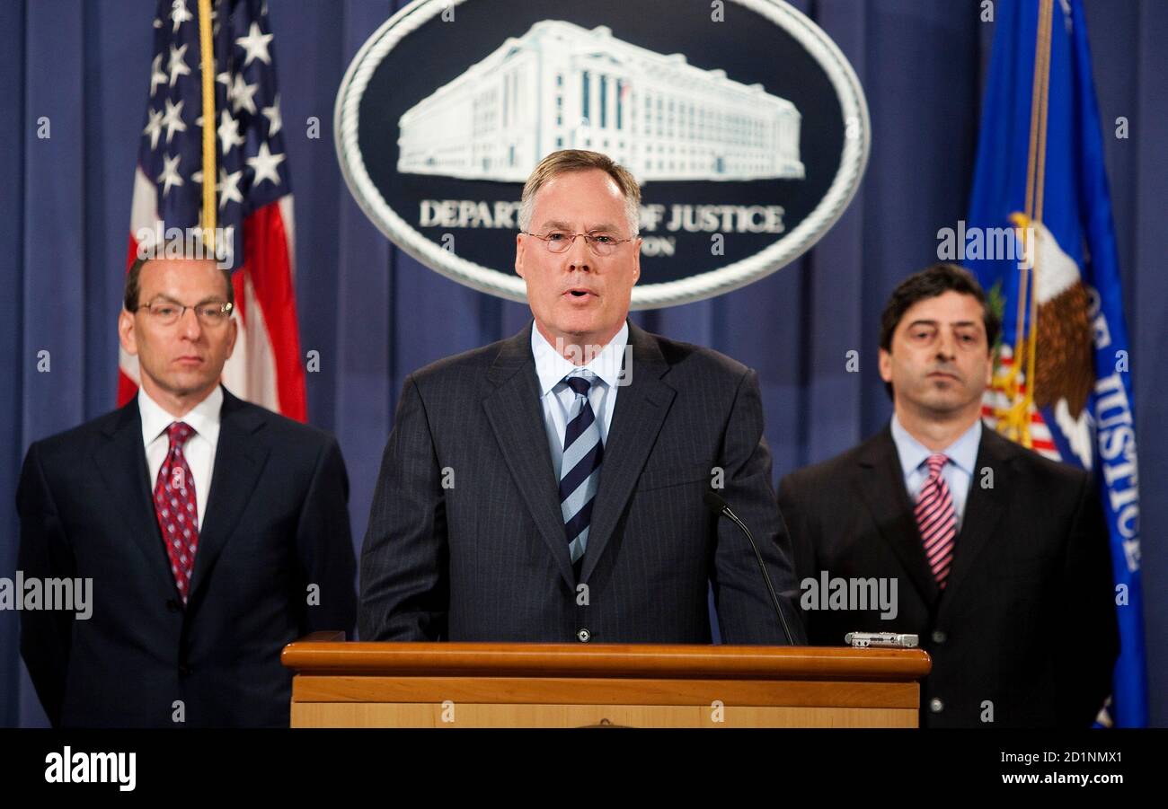 Tim Johnson (C), US Attorney of the Southern Disctrict of Texas, speaks as Lanny A. Breuer (L), Assistant Attorney General for the Criminal Division at the US Department of Justice and Robert Khuzami Director of Enforcement at the Securities Exchange Commission listen to an announcement of indictments against Robert Allen Stanford, Chairman of the Stanford Financial Group on fraud and obstruction charges related to a $7 billion scheme to defraud investors in Washington, June 19, 2009.   REUTERS/Joshua Roberts    (UNITED STATES CRIME LAW BUSINESS) Stock Photo