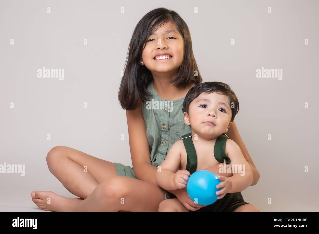 Mexican siblings smiling and cryingisolated Stock Photo