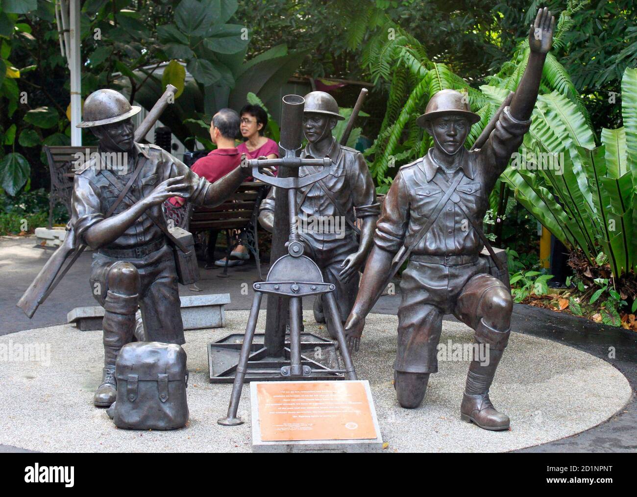 Visitors Sit Next To A War Memorial Depicting A Malay Regiment Mortar Crew At Bukit Chandu In Kent Ridge Park In Singapore March 6 2010 The Park Was The Site Of A