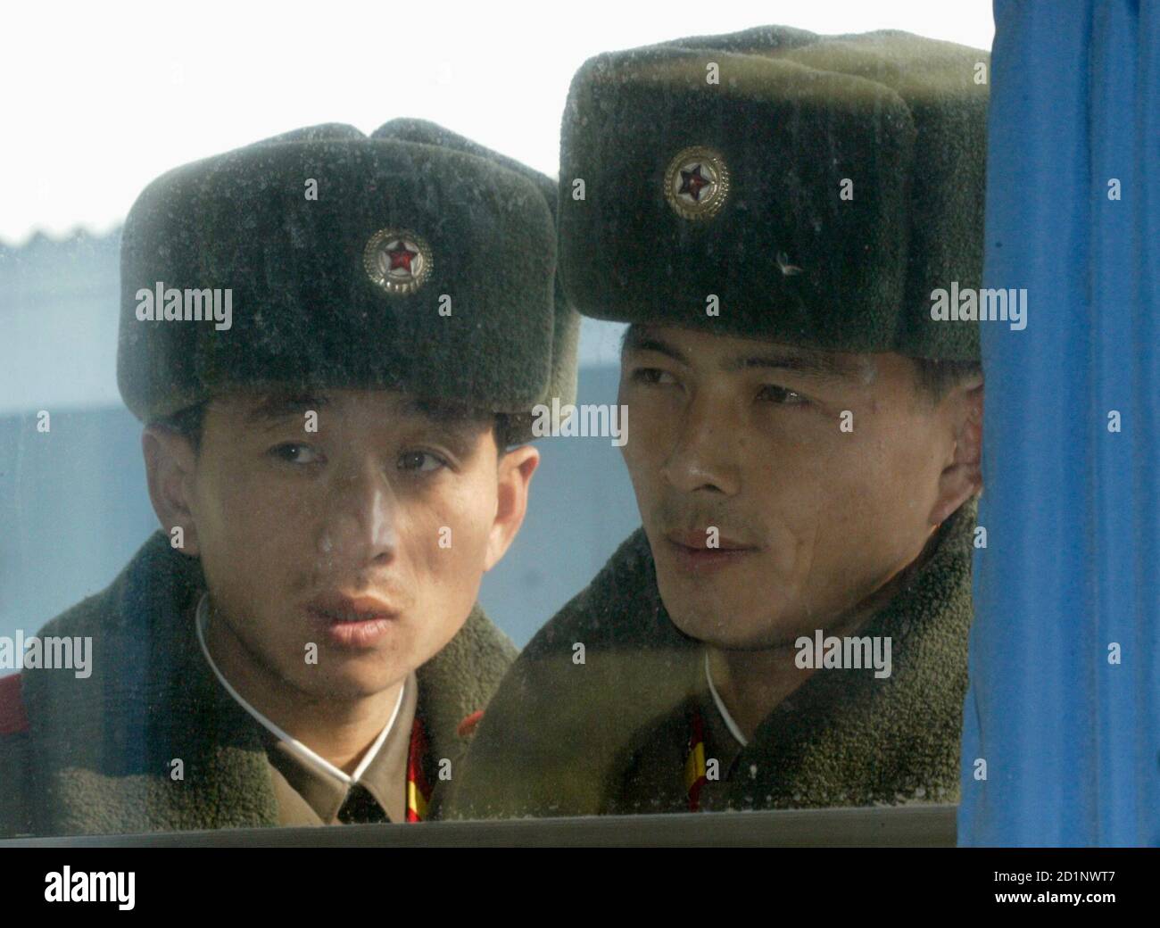 North Korean soldiers look through the 