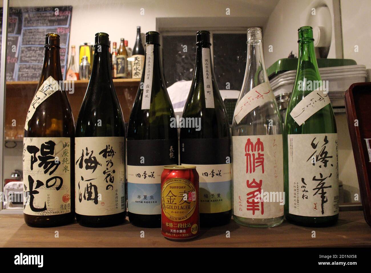 Can of Suntory beer among Japanese sake bottles Stock Photo Alamy