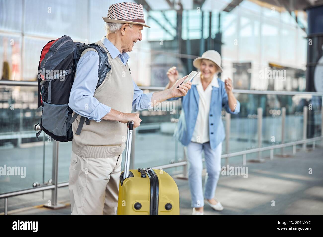 Concentrated senior man using his smartphone outdoors Stock Photo